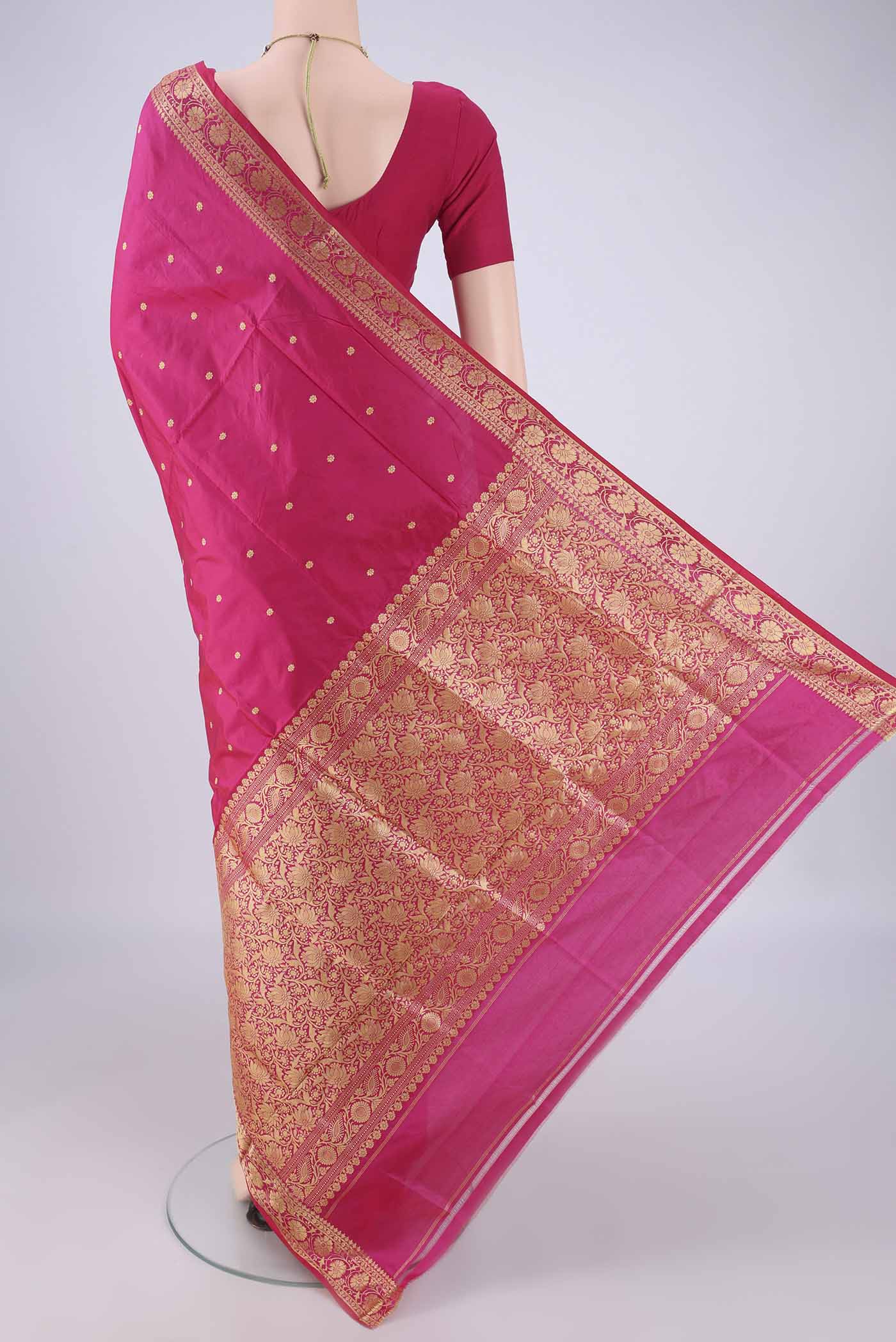 Flat view of Rani Pink Banarasi Silk Saree with Thread Butta on the body and Thread Border. 