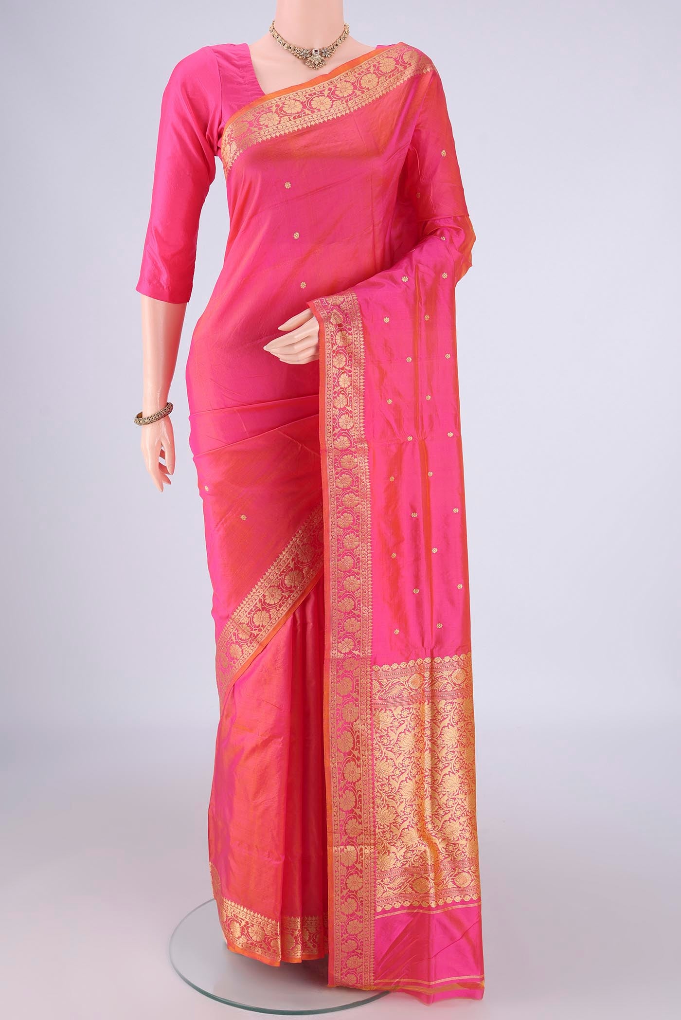 Peach Banarasi Katan Silk Saree with Zari Butta on the body and Zari Border.  displayed on a mannequin