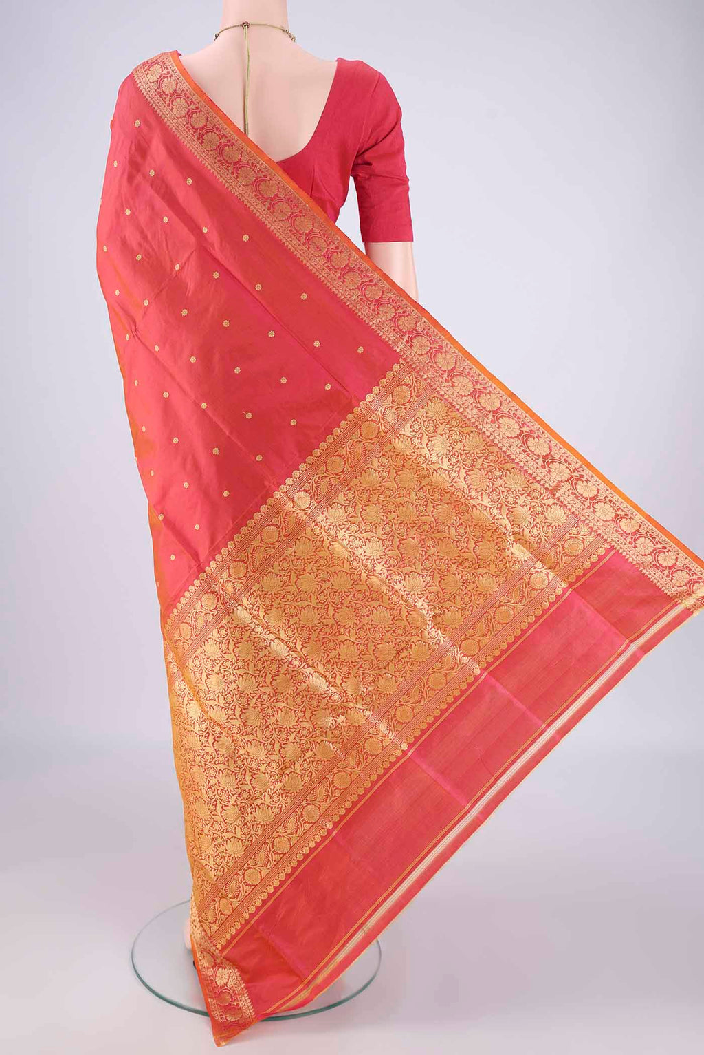 Flat view of Brick Orange Banarasi Katan Silk Saree with Thread Butta on the body and Thread Border. 