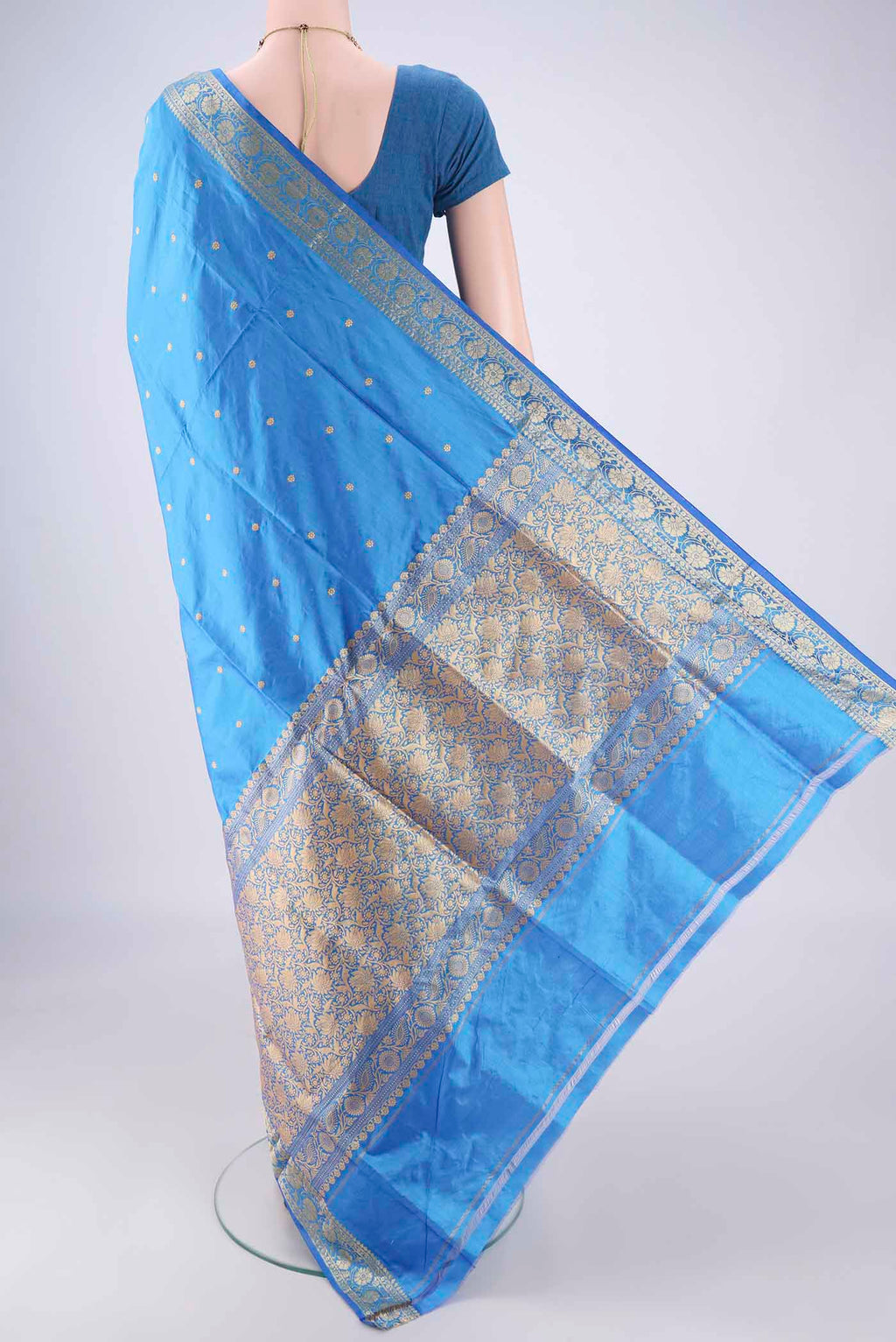 Flat view of Blue Dual Tone Banarasi Katan Silk Saree with Zari Butta on the body and Zari Border. 