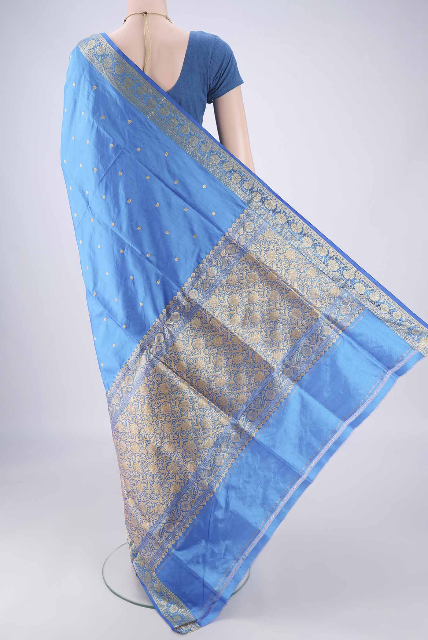 Flat view of Blue Dual Tone Banarasi Katan Silk Saree with Zari Butta on the body and Zari Border. 