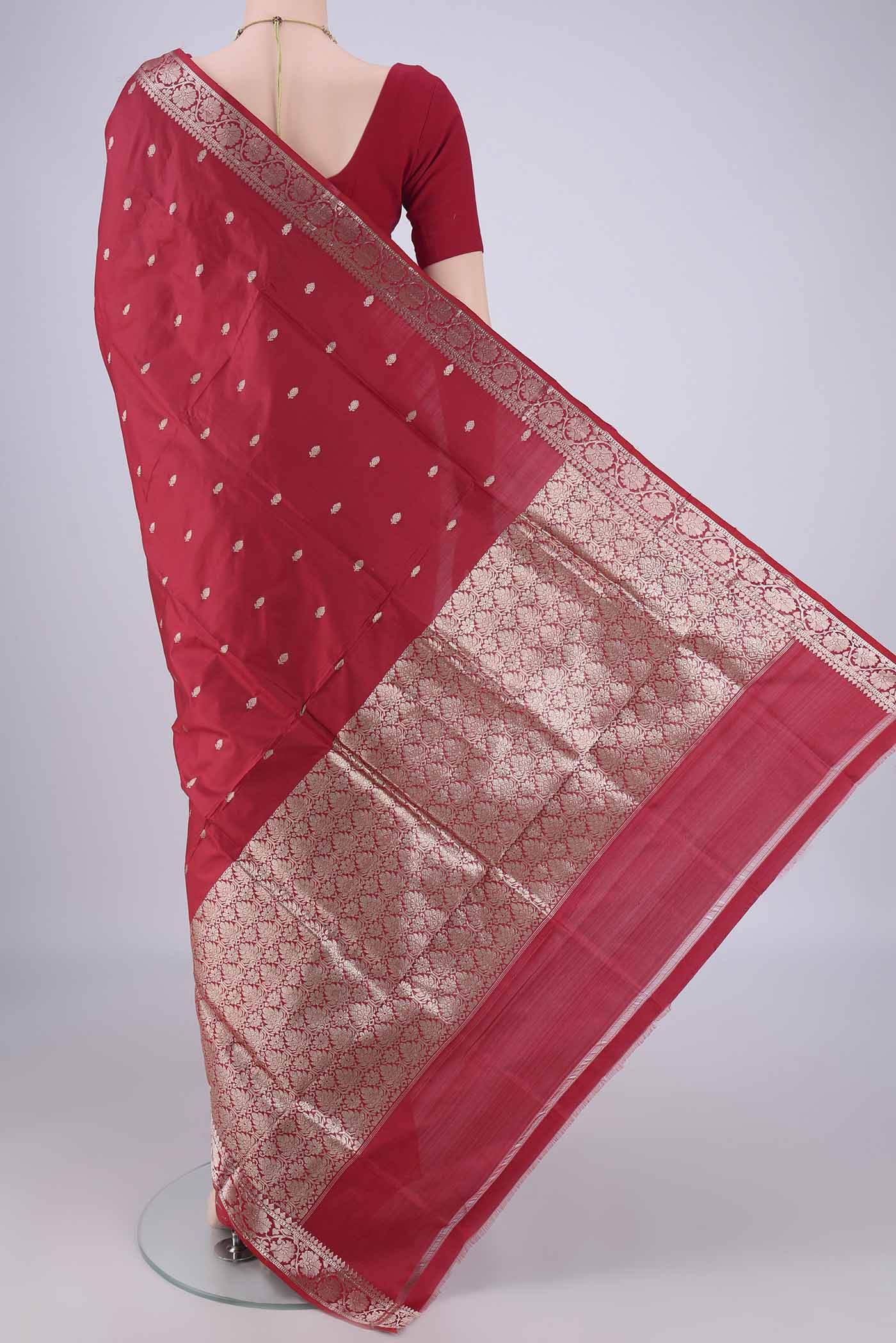 Flat view of Maroon Banarasi Katan Silk Saree with Zari Butta on the body and Zari Border. 