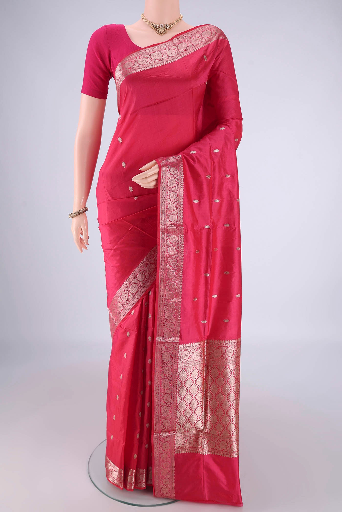 Dark Pink Banarasi Katan Silk Saree with Zari Butta on the body and Zari Border.  displayed on a mannequin