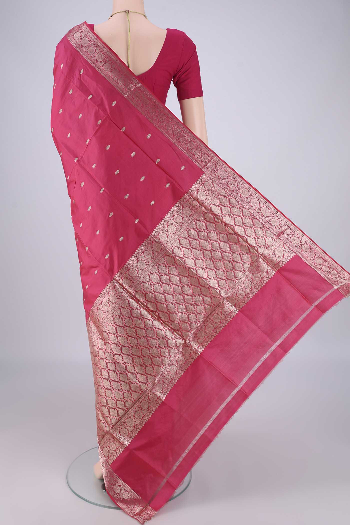 Flat view of Dark Pink Banarasi Katan Silk Saree with Zari Butta on the body and Zari Border. 