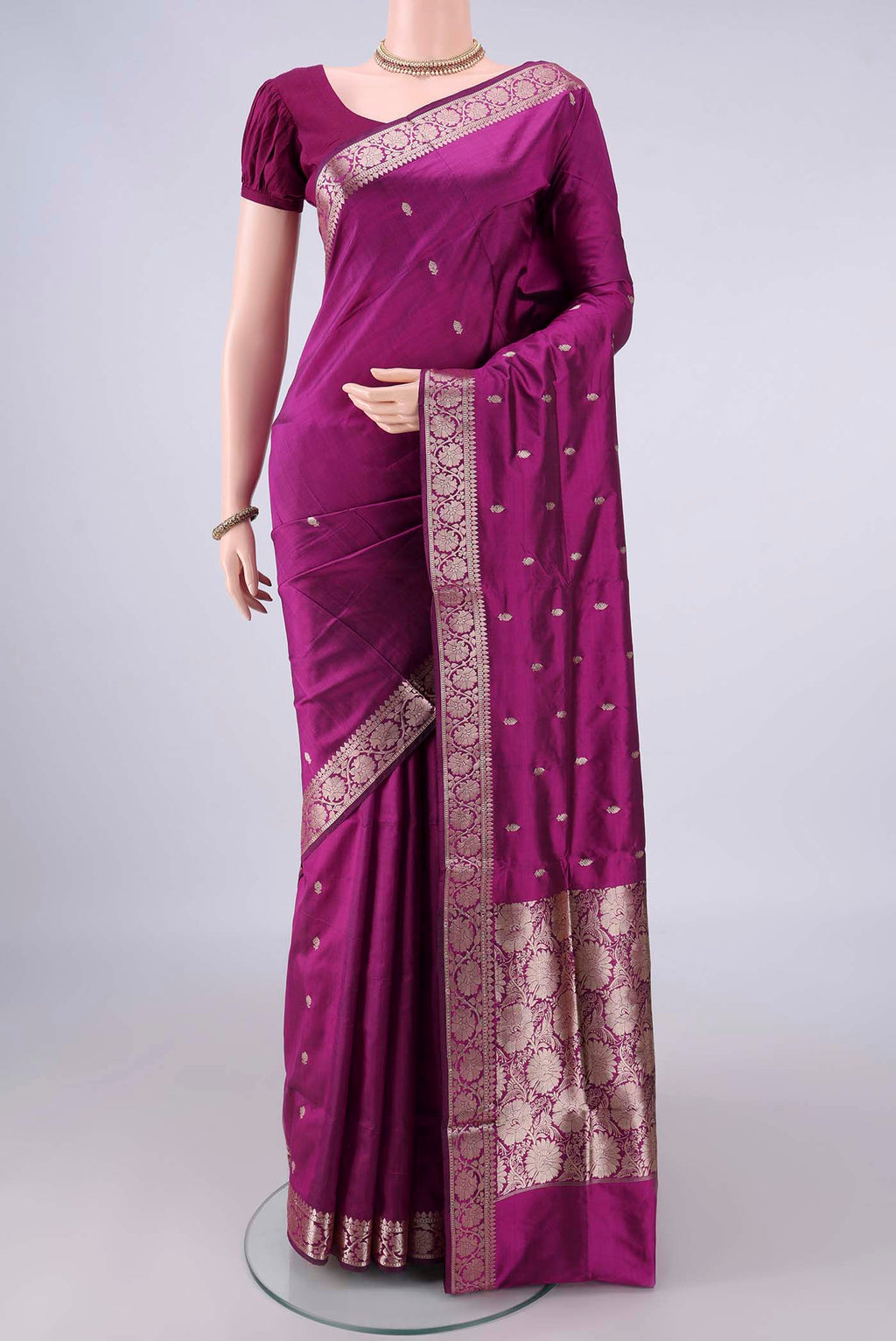 Pure Silk Magenta Banarasi Katan Saree with Zari Butta on the body and Zari Border.  displayed on a mannequin