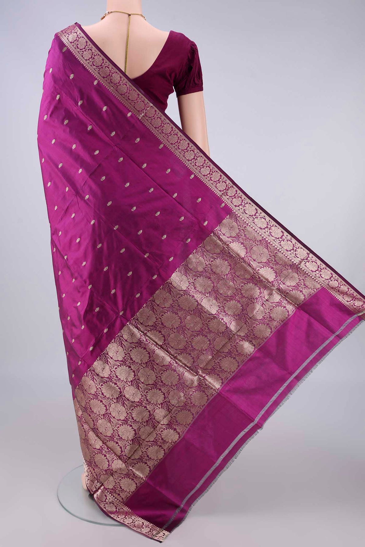 Flat view of Pure Silk Magenta Banarasi Katan Saree with Zari Butta on the body and Zari Border. 