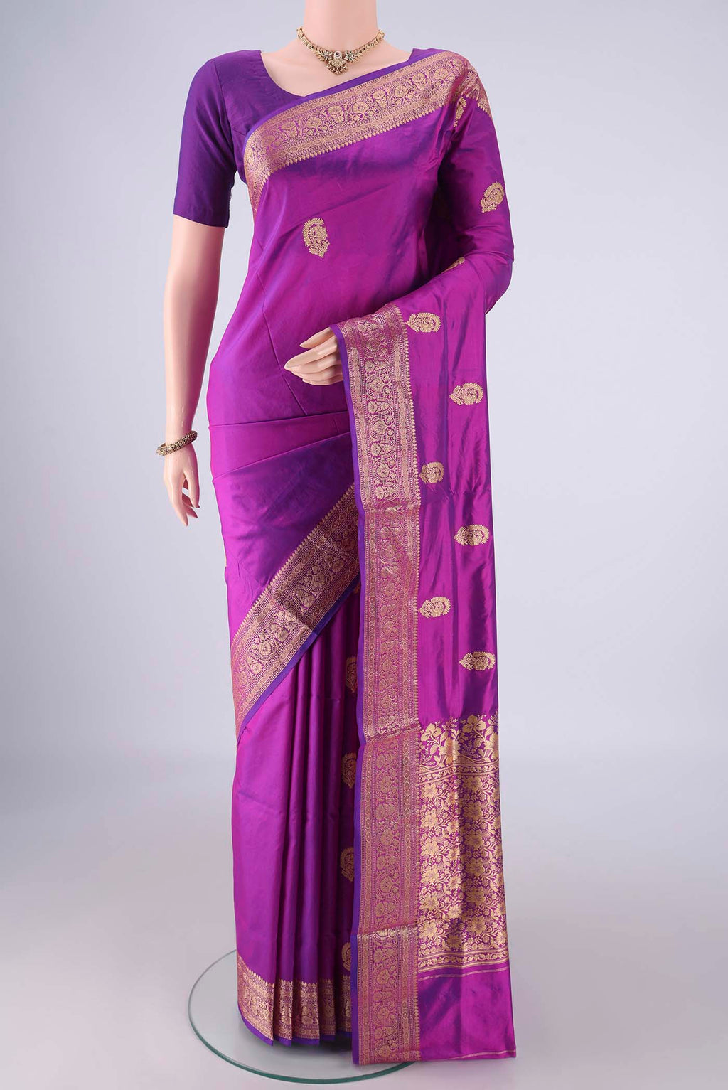 Magenta Banarasi Katan Silk Saree with Thread Butta on the body and Thread Border.  displayed on a mannequin