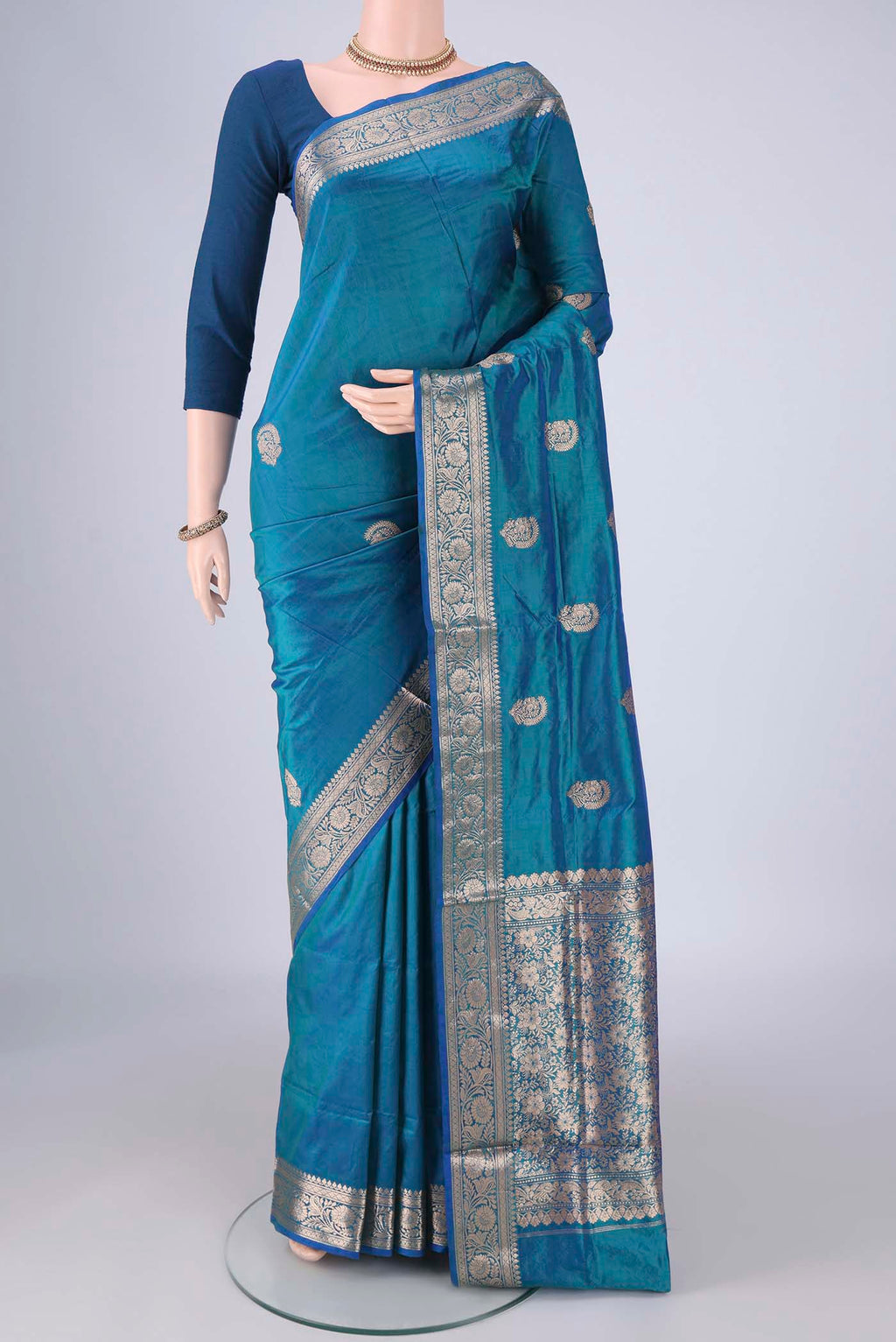 Peacock Blue Dual Tone Banarasi Katan Silk Saree with Zari Butta on the body and Zari Border.  displayed on a mannequin