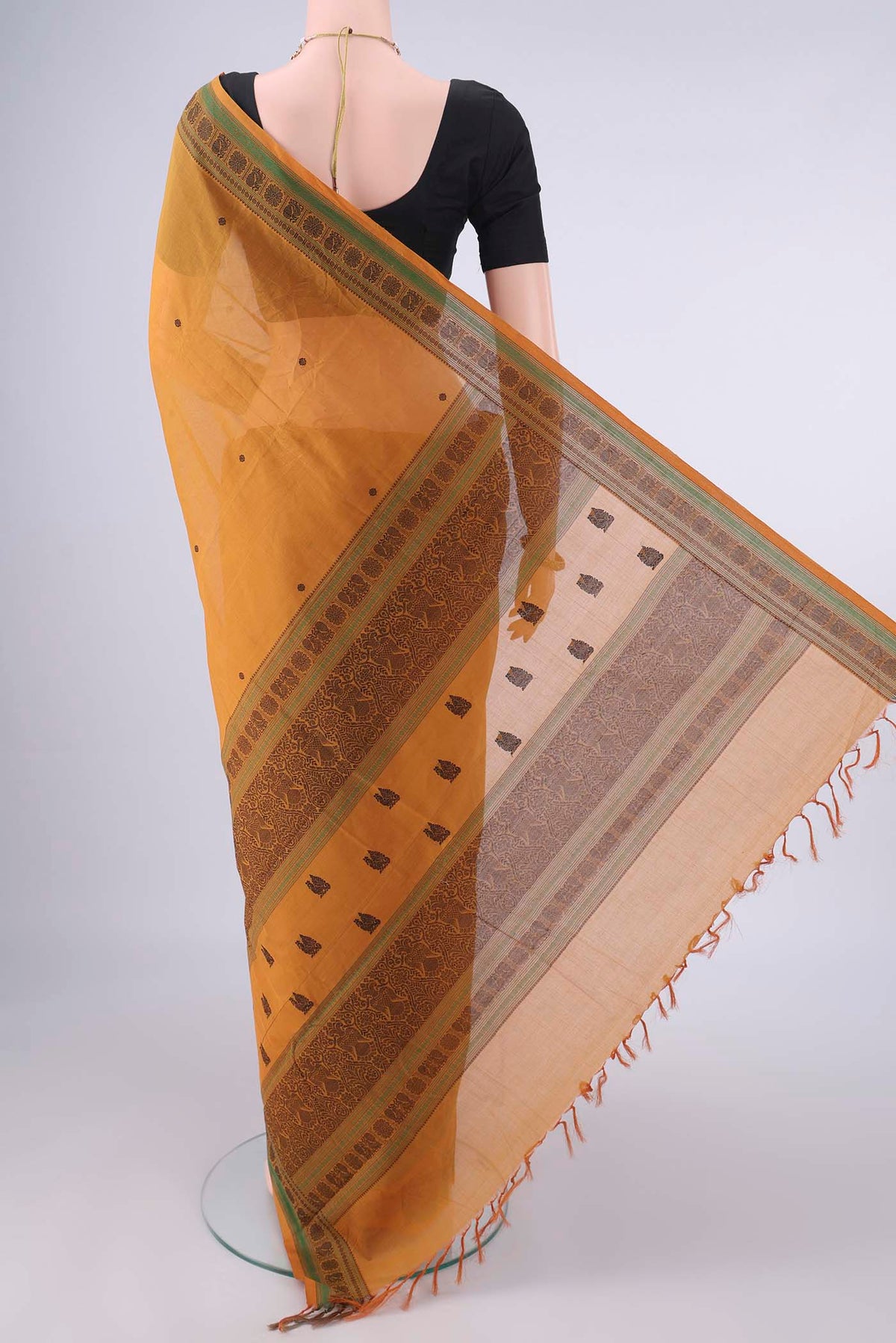 Flat view of Mustard Kanchi Cotton Saree with Thread Butta on the body and Thread Border. 