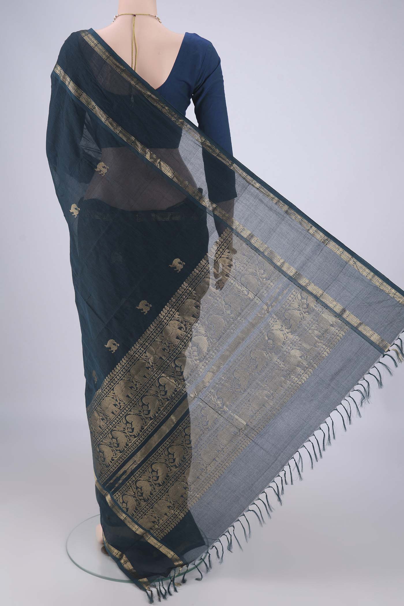 Flat view of Teal Kanchi Cotton Saree with Zari Butta on the body and Zari Border. 