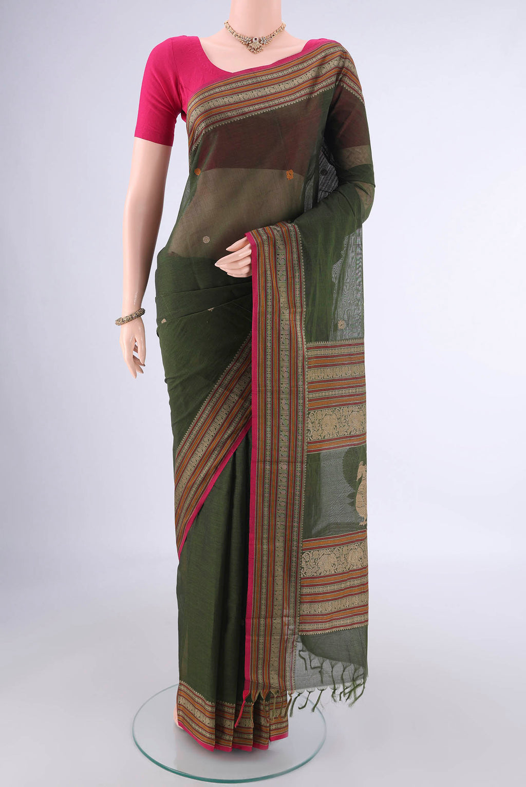 Mehandi Green Kanchi Cotton Saree with Thread Butta on the body and Thread Border.  displayed on a mannequin