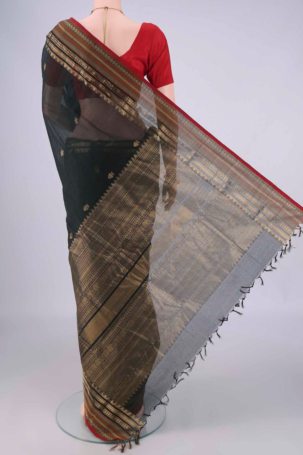 Flat view of Bottle Green Kanchi Cotton Saree with Zari Butta on the body and Zari Border. 
