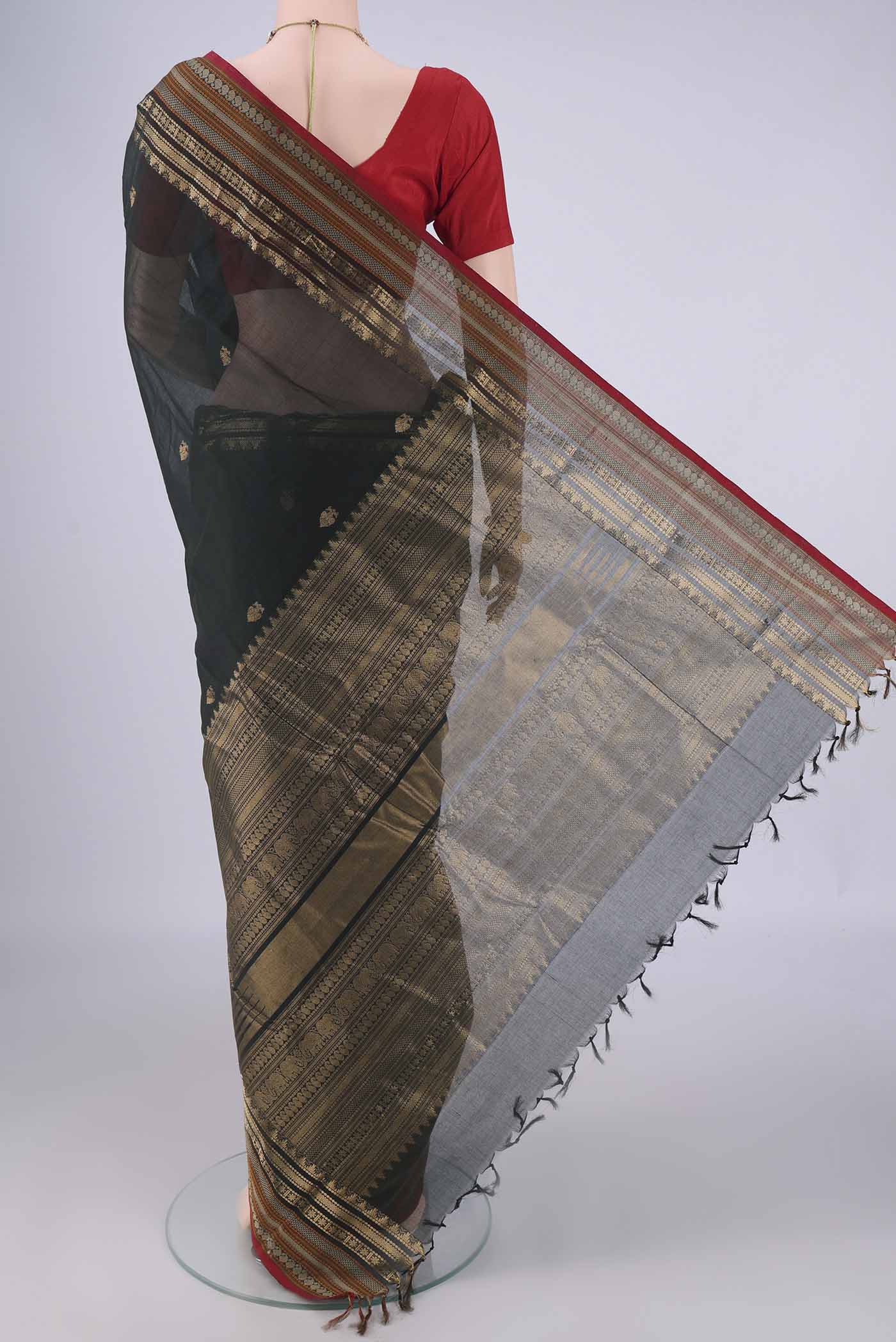 Flat view of Bottle Green Kanchi Cotton Saree with Zari Butta on the body and Zari Border. 