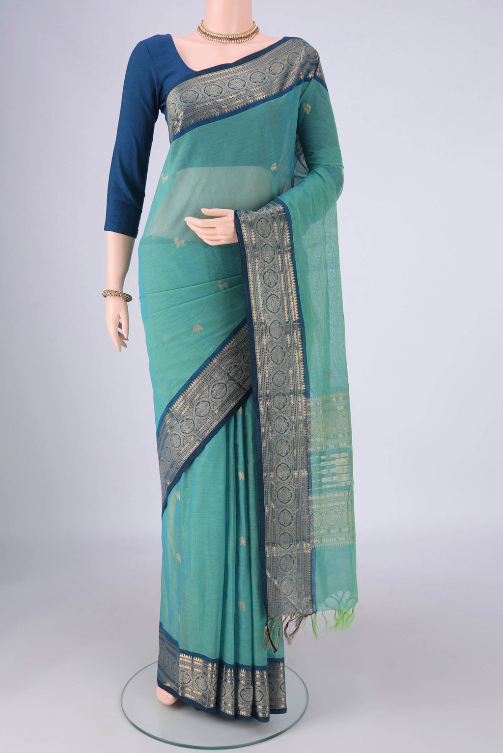 Sea Green Kanchi Cotton Saree with Zari Butta on the body and Zari Border.  displayed on a mannequin