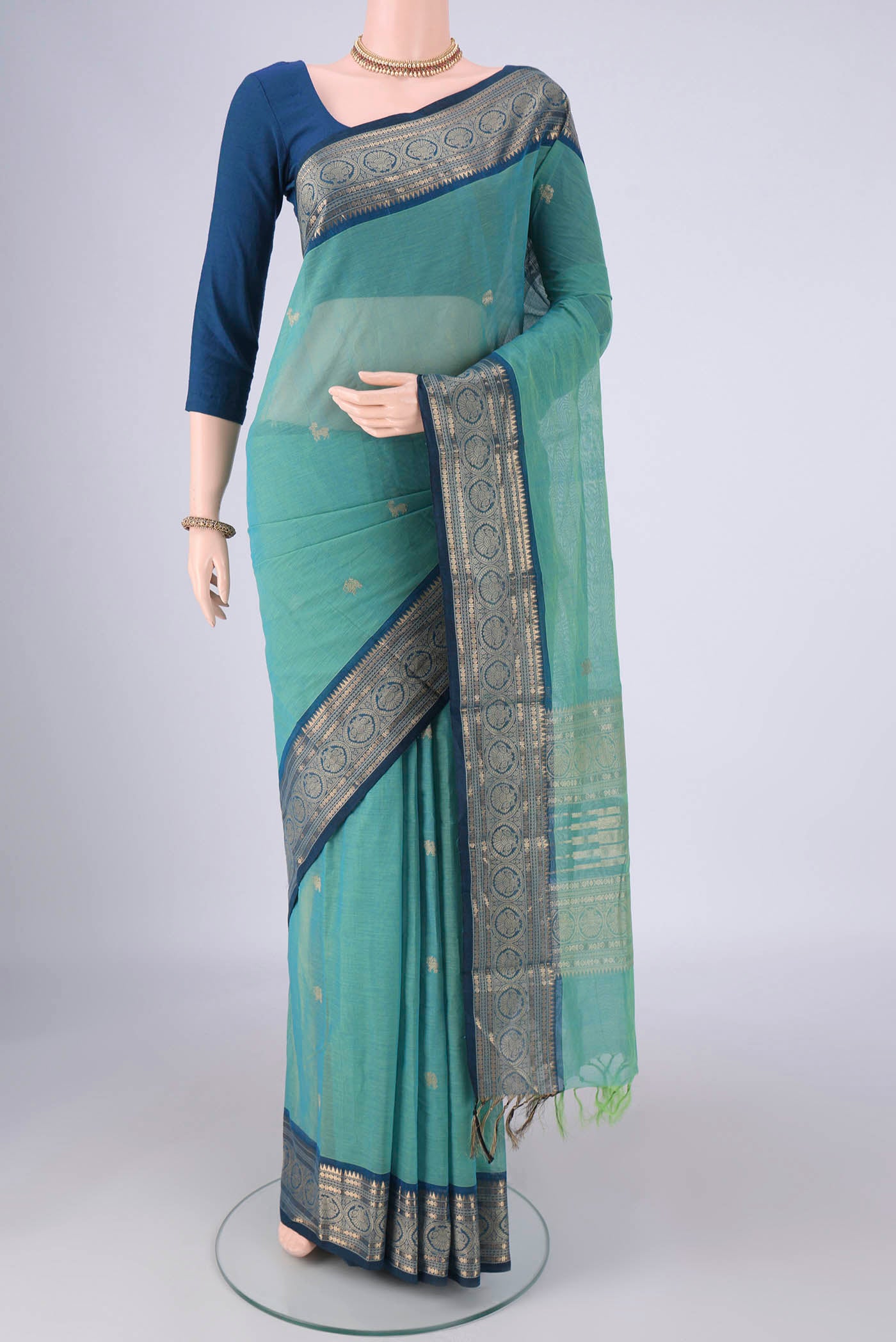 Sea Green Kanchi Cotton Saree with Zari Butta on the body and Zari Border.  displayed on a mannequin