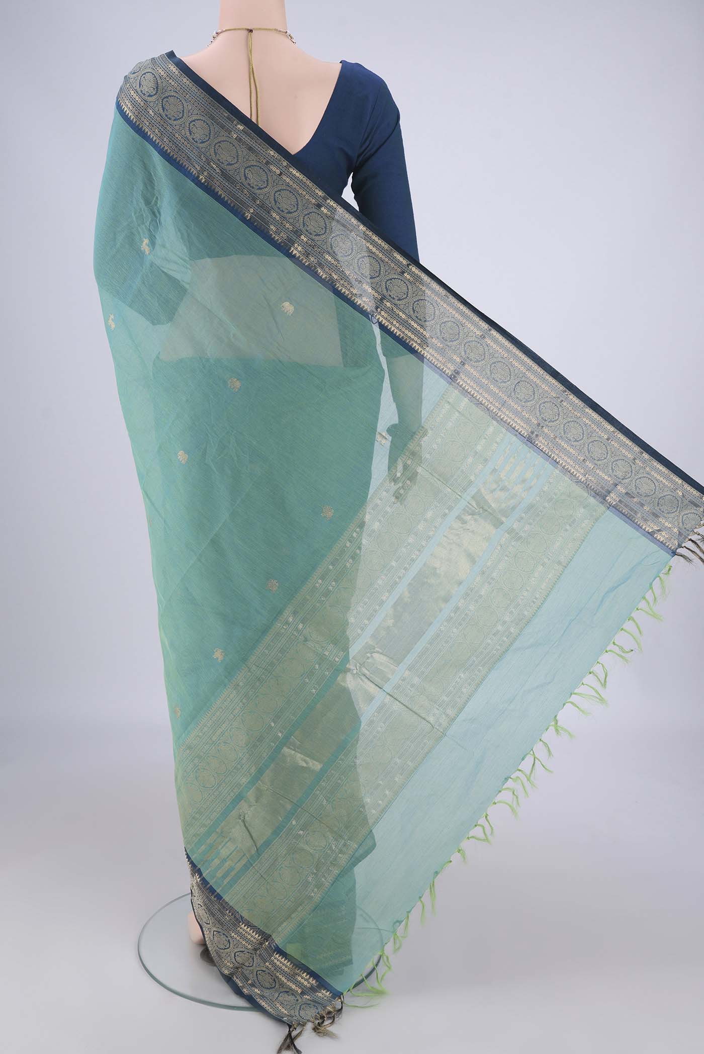 Flat view of Sea Green Kanchi Cotton Saree with Zari Butta on the body and Zari Border. 