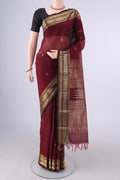 Maroon Kanchi Cotton Saree with Zari Butta on the body and Zari Border.  displayed on a mannequin