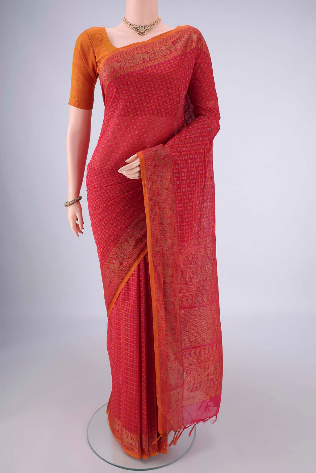 Pink Kanchi Cotton Saree with Checked design on the body and Thread Border.  displayed on a mannequin