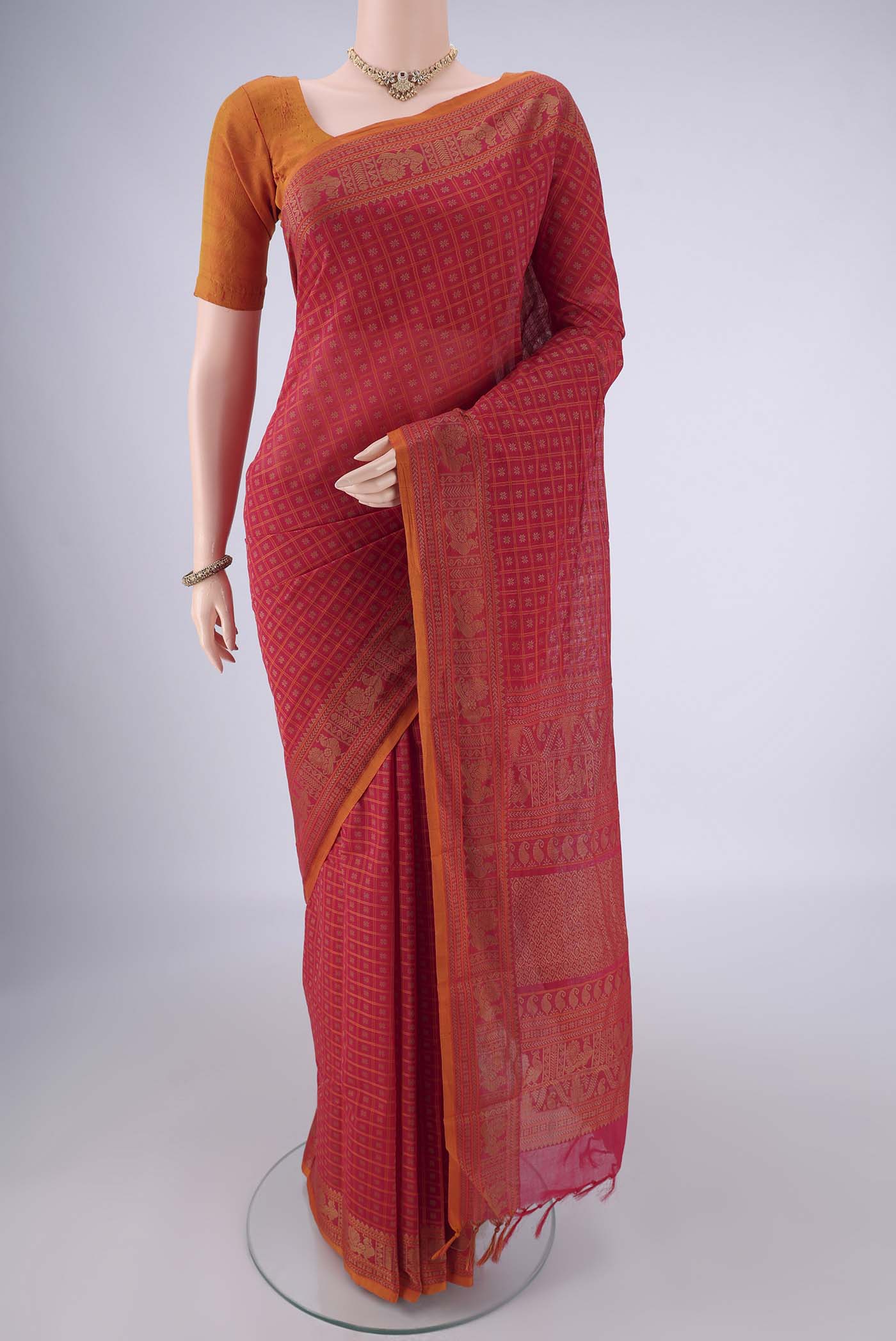 Pink Kanchi Cotton Saree with Checked design on the body and Thread Border.  displayed on a mannequin