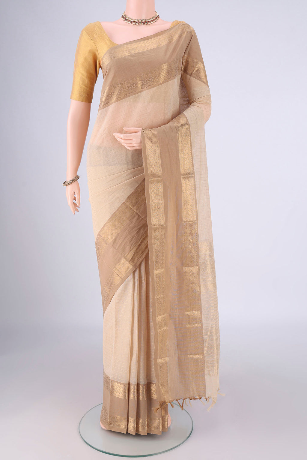 Cream Kanchi Cotton Saree with Checked design on the body and Zari Border.  displayed on a mannequin