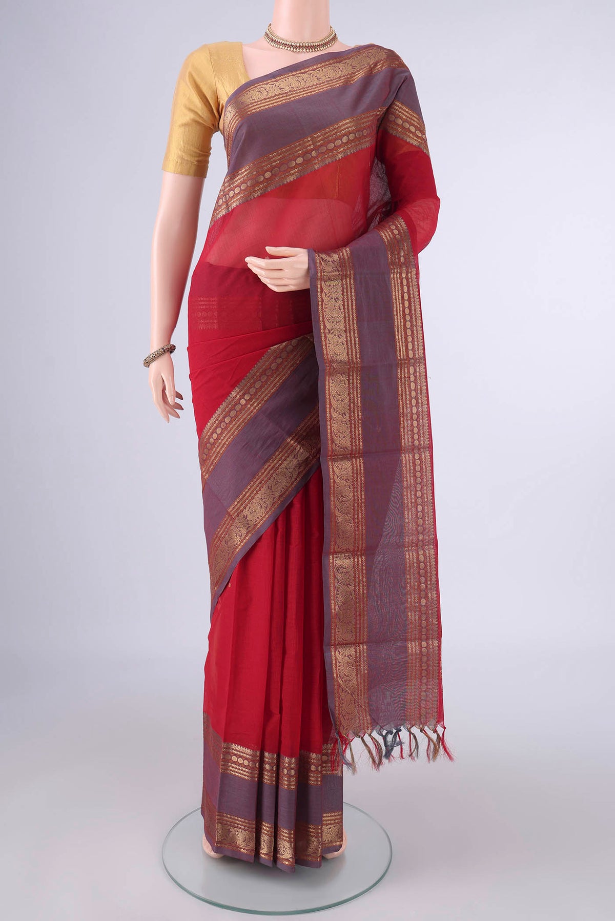 Red Kanchi Cotton Saree with Plain Body and Zari Border.  displayed on a mannequin