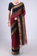 Maroon Kanchi Cotton Saree with Zari Butta on the body and Zari Border.  displayed on a mannequin