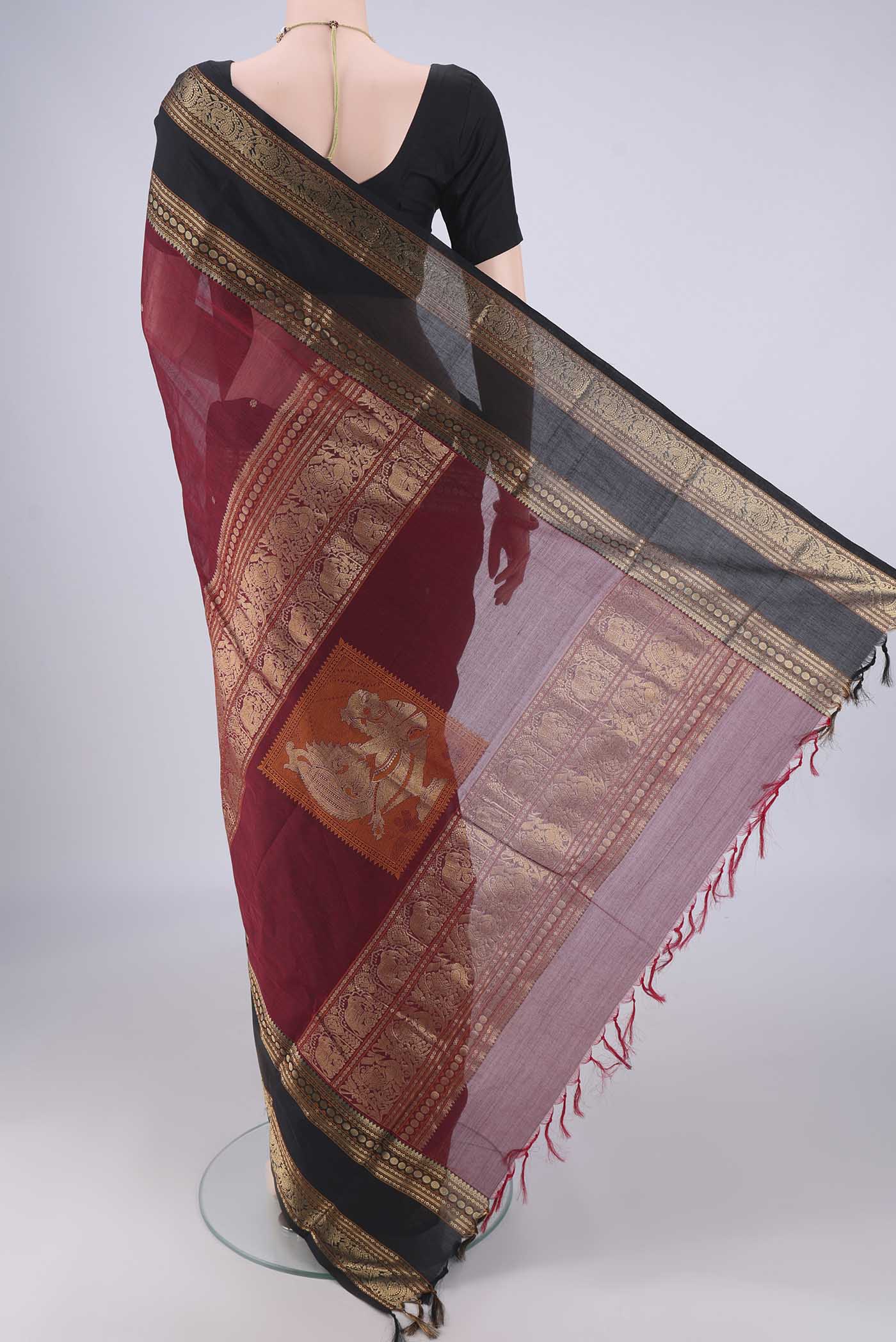 Flat view of Maroon Kanchi Cotton Saree with Zari Butta on the body and Zari Border. 