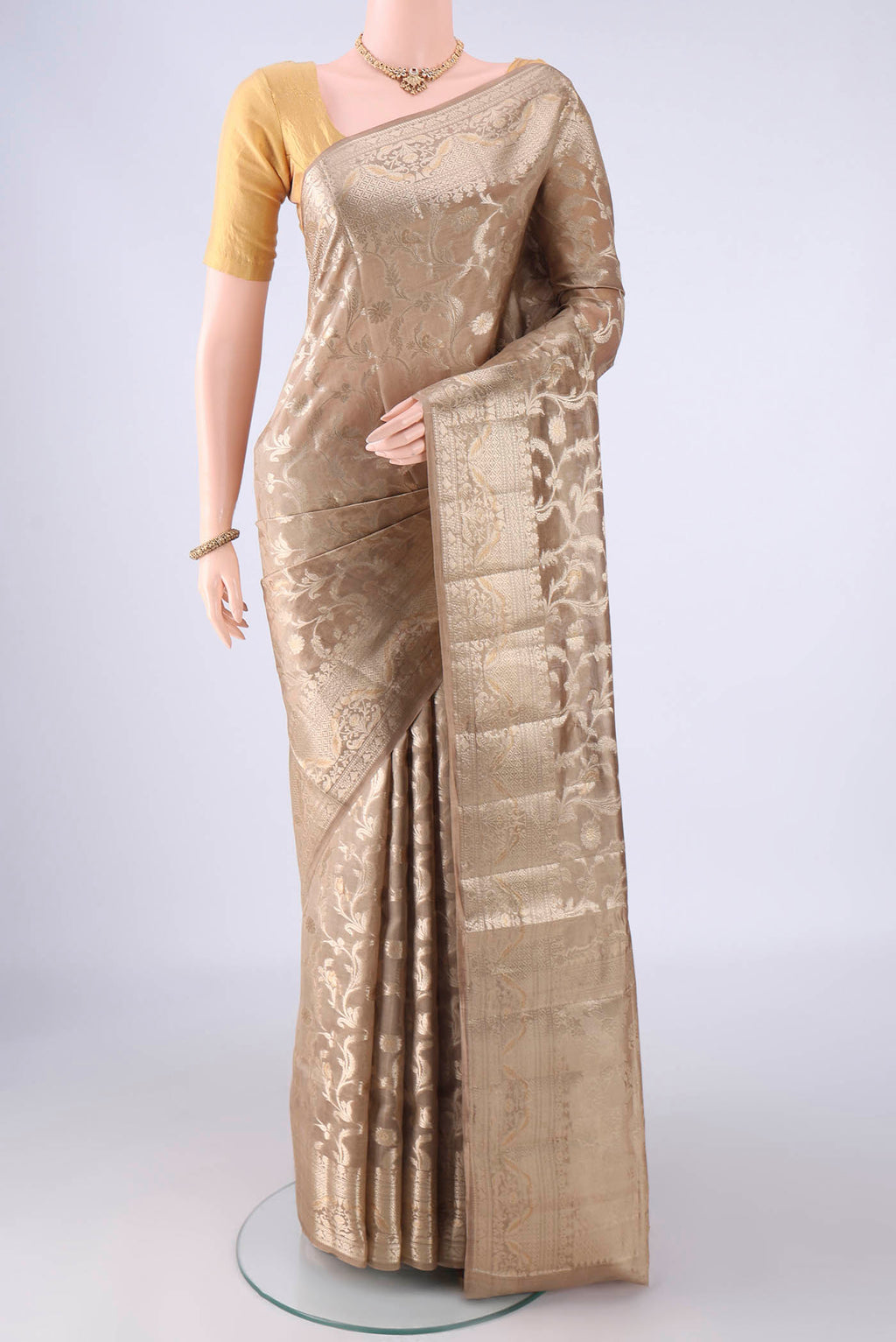Dark Beige Banarasi Raw Silk Saree with Zari Brocade on the body and Zari Border.  displayed on a mannequin