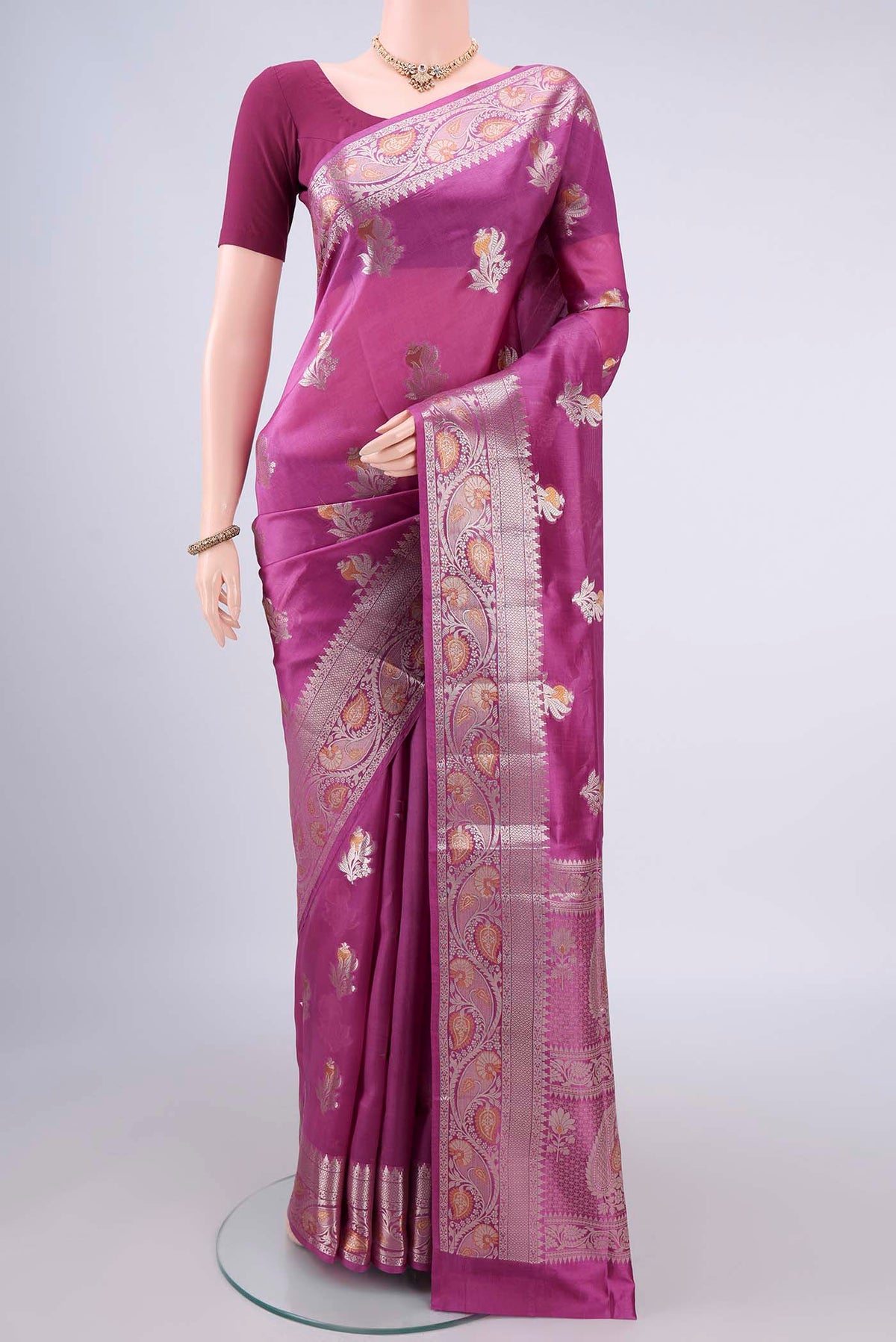 Pure Silk Pink Banarasi Raw Saree with Zari And Thread Butta on the body and Zari Border.  displayed on a mannequin