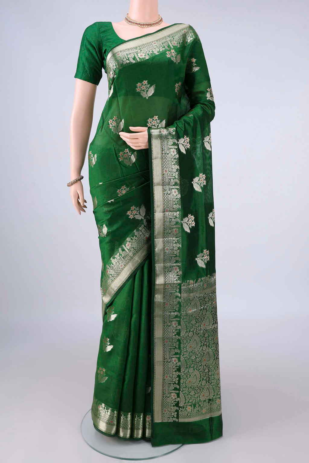 Pure Silk Green Banarasi Tussar Saree with Zari And Thread Butta on the body and Zari Border.  displayed on a mannequin