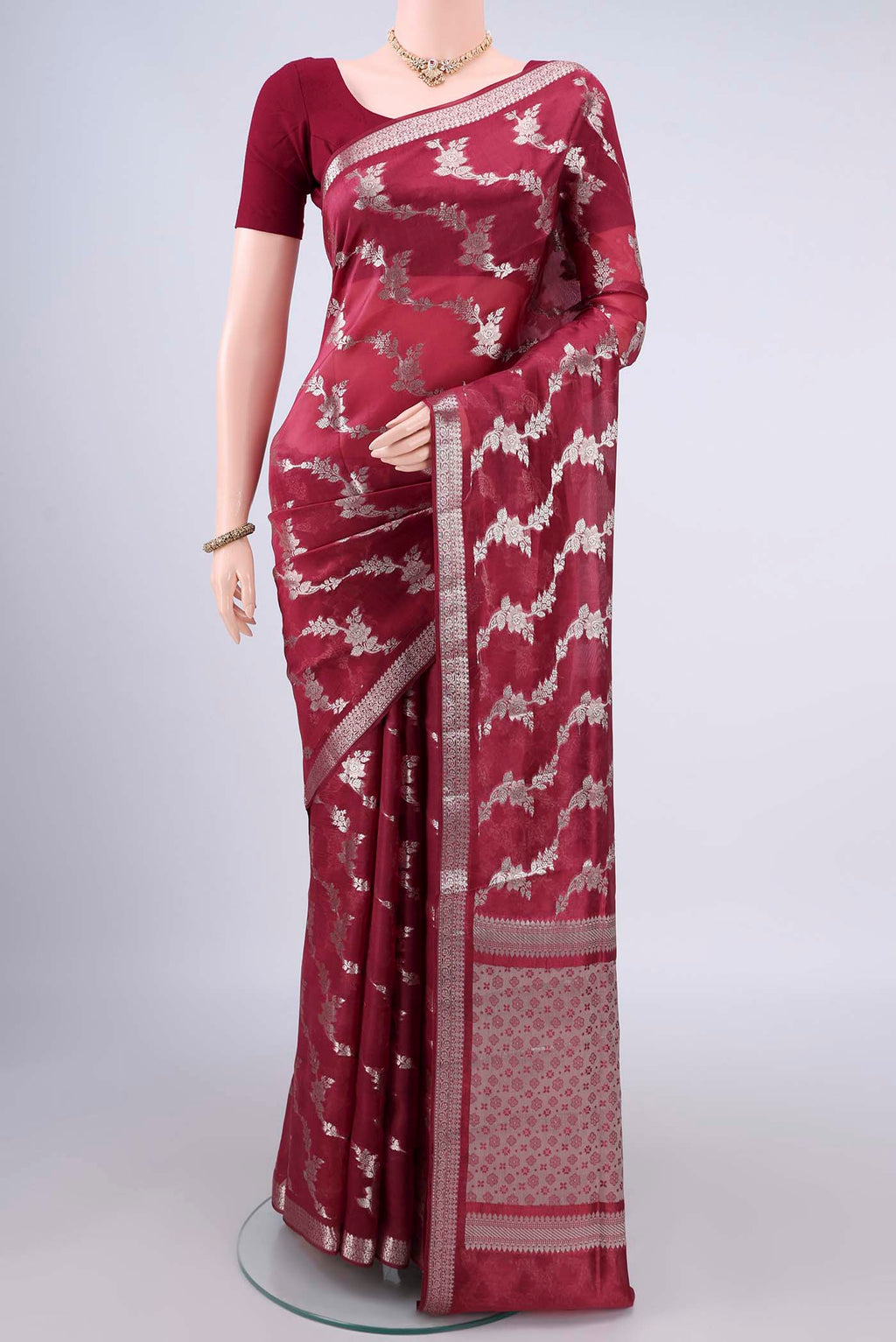 Pure Silk Maroon Banarasi Raw Saree with Zari And Thread Butta on the body and Zari Border.  displayed on a mannequin