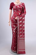 Pure Silk Maroon Banarasi Raw Saree with Zari And Thread Butta on the body and Zari Border.  displayed on a mannequin