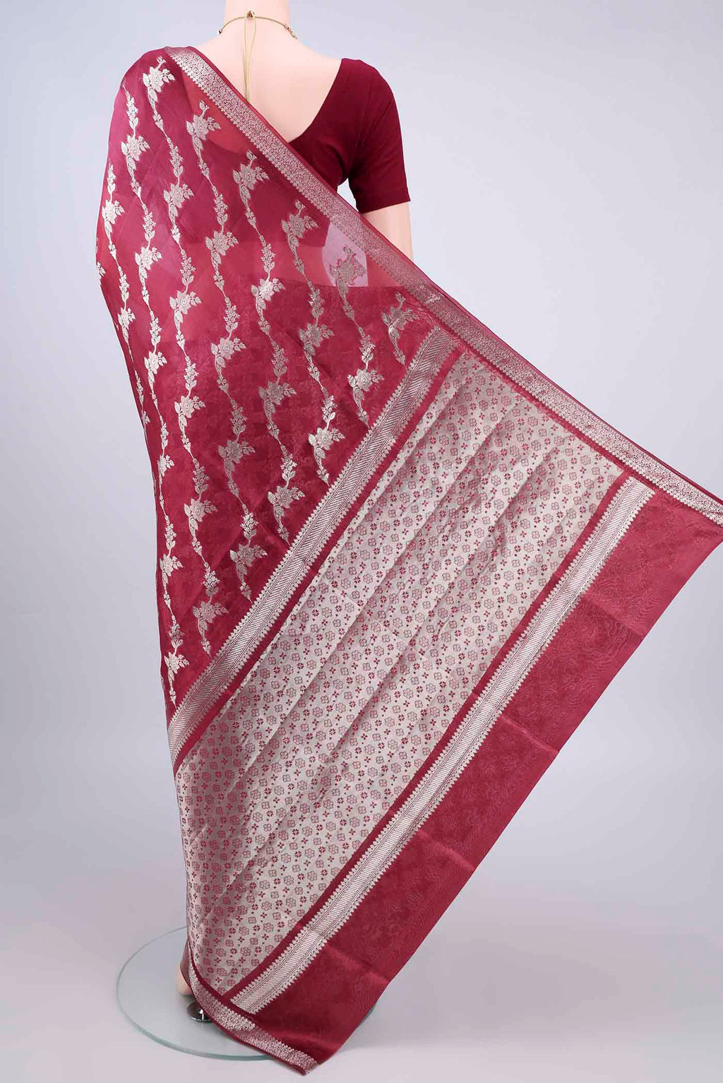 Flat view of Pure Silk Maroon Banarasi Raw Saree with Zari And Thread Butta on the body and Zari Border. 