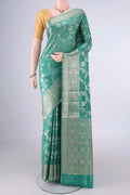 Pure Silk Sea Green Banarasi Raw Saree with Zari Brocade on the body and Zari Border.  displayed on a mannequin