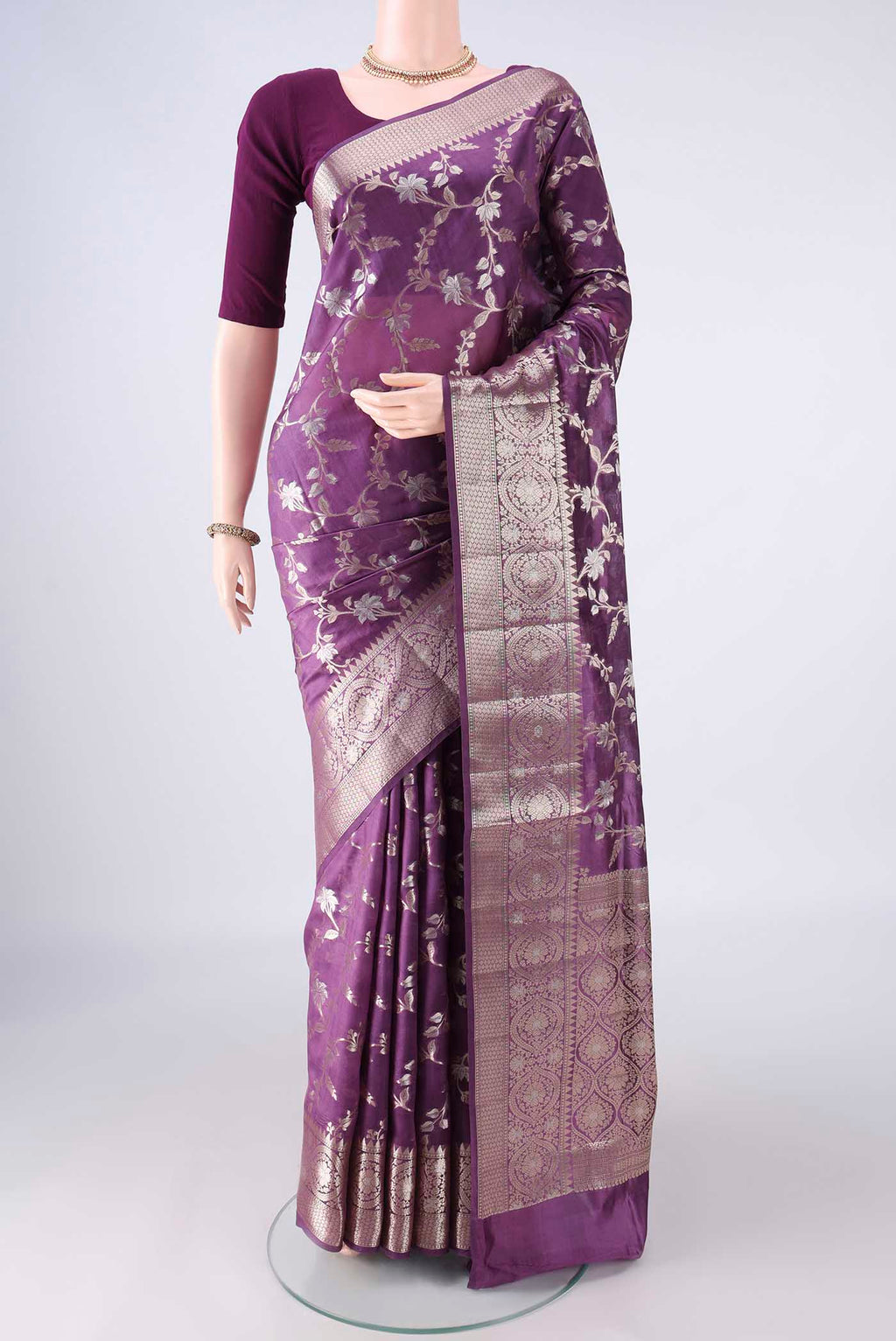 Pure Silk Purple Banarasi Raw Saree with Zari Butta on the body and Zari Border.  displayed on a mannequin
