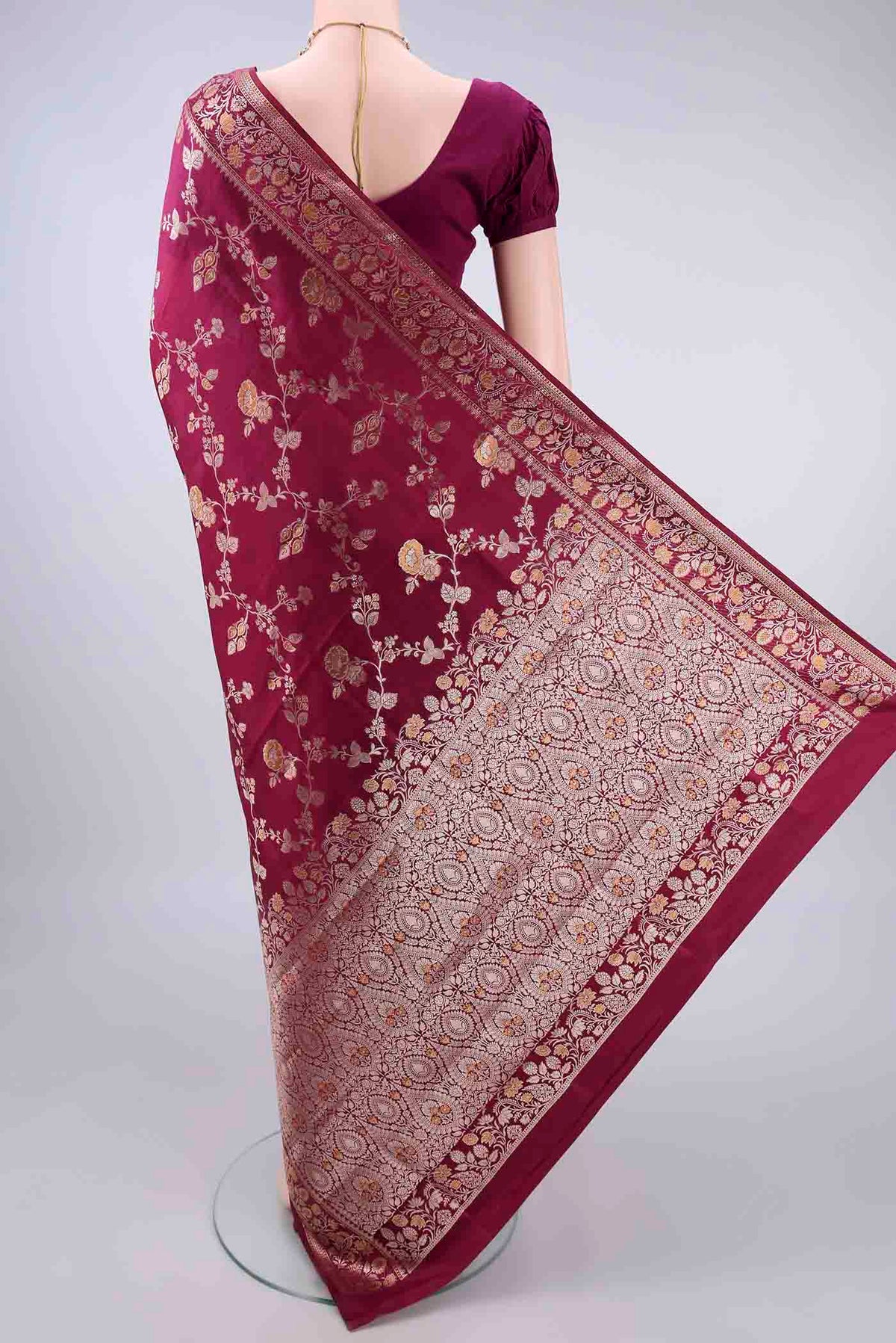 Flat view of Pure Silk Maroon Banarasi Raw Saree with Zari And Thread Butta on the body and Zari Border. 