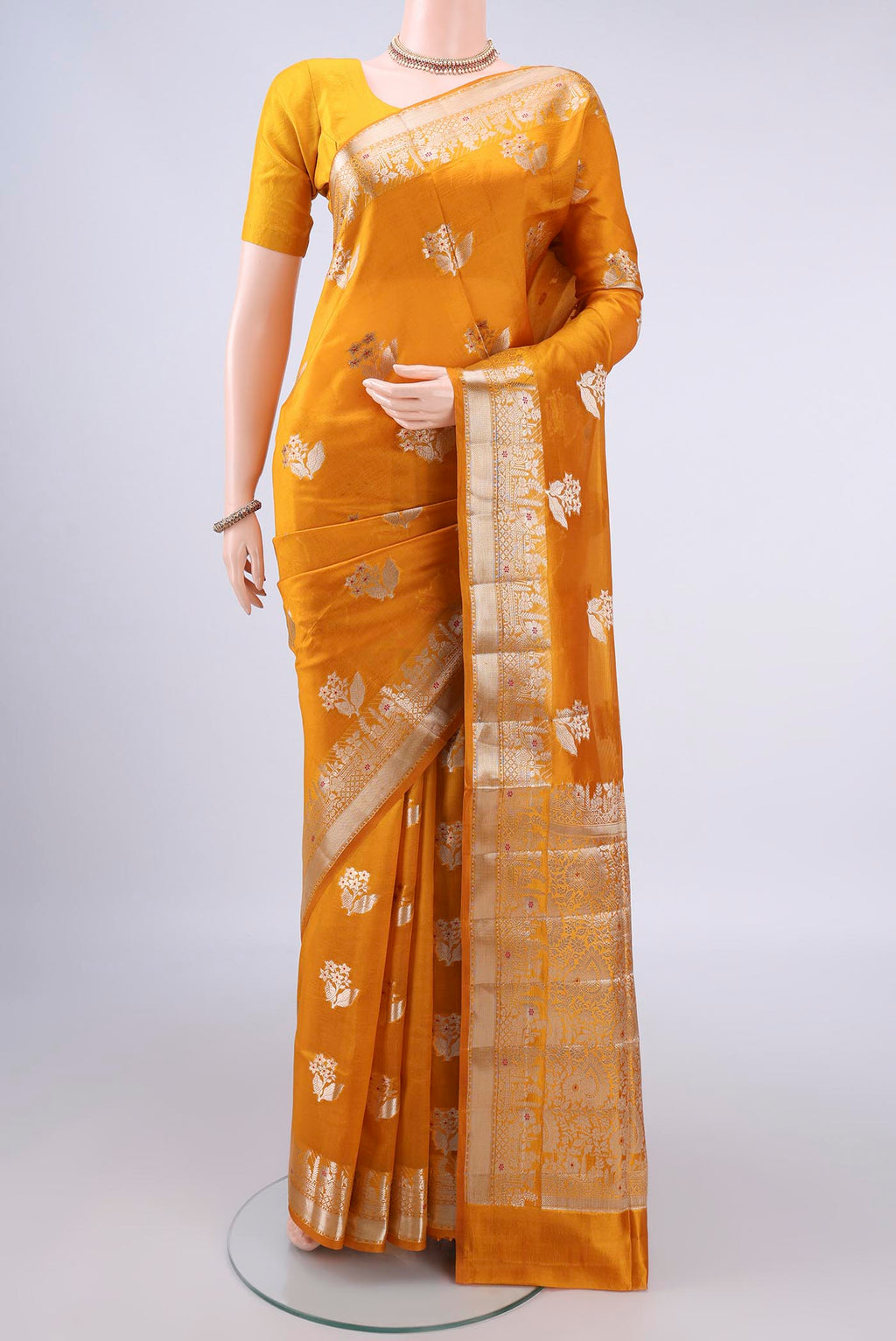 Pure Silk Yellow Banarasi Raw Saree with Zari And Thread Butta on the body and Zari Border.  displayed on a mannequin
