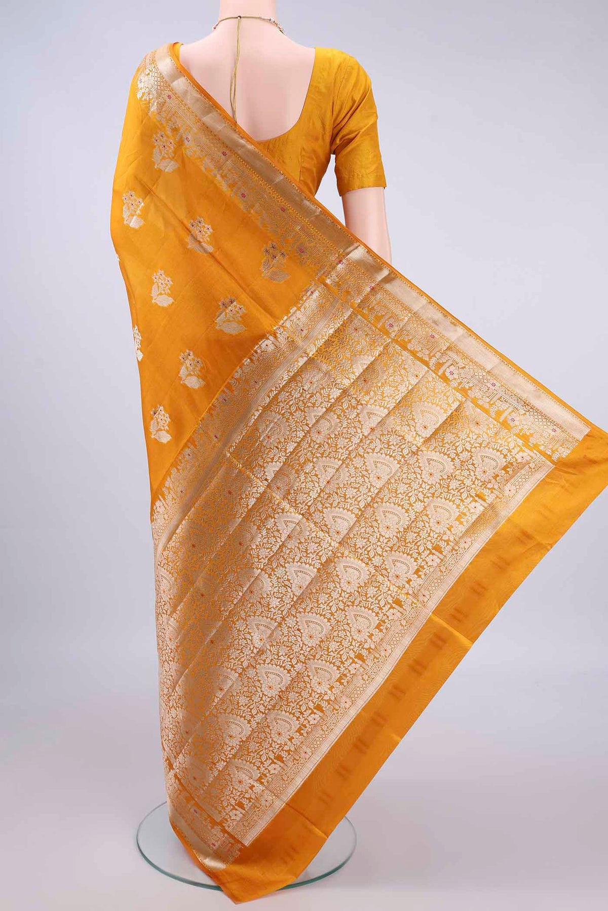 Flat view of Pure Silk Yellow Banarasi Raw Saree with Zari And Thread Butta on the body and Zari Border. 