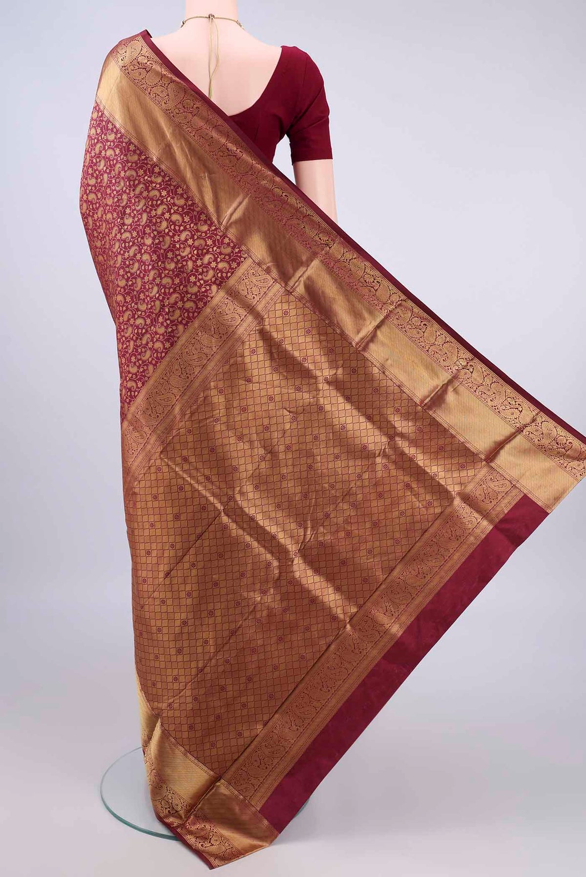 Flat view of Pure Silk Maroon Kanjivaram Saree with Zari Brocade on the body and Zari Border. 