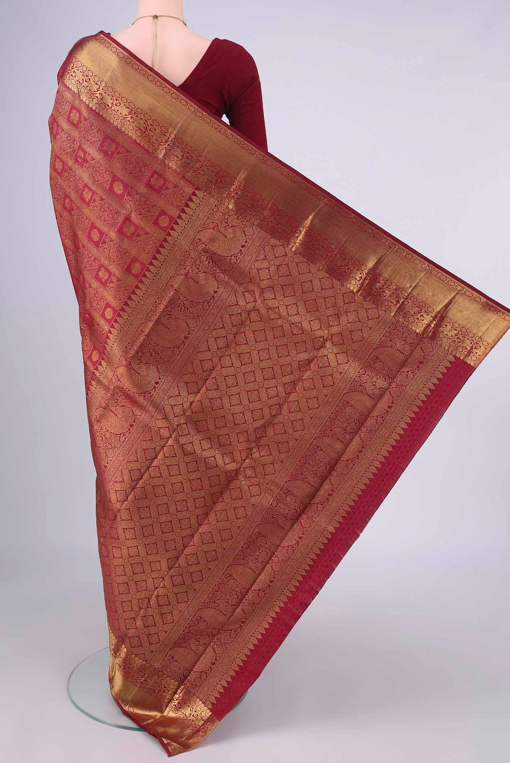 Flat view of Pure Silk Maroon Kanchipuram Saree with Zari Brocade on the body and Zari Border. 