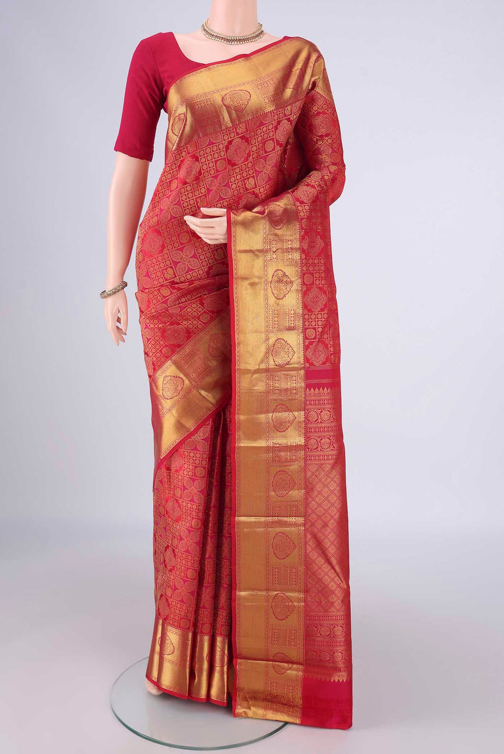 Dark Pink Kanchipuram Silk Saree with Zari Brocade on the body and Zari Border.  displayed on a mannequin