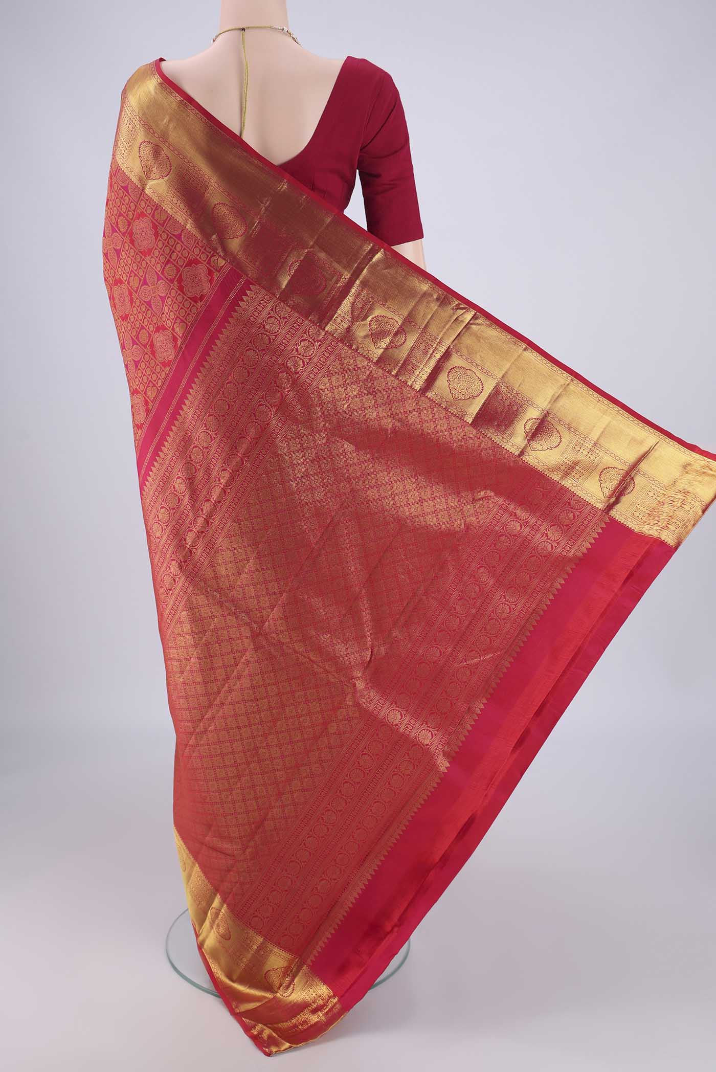 Flat view of Dark Pink Kanchipuram Silk Saree with Zari Brocade on the body and Zari Border. 