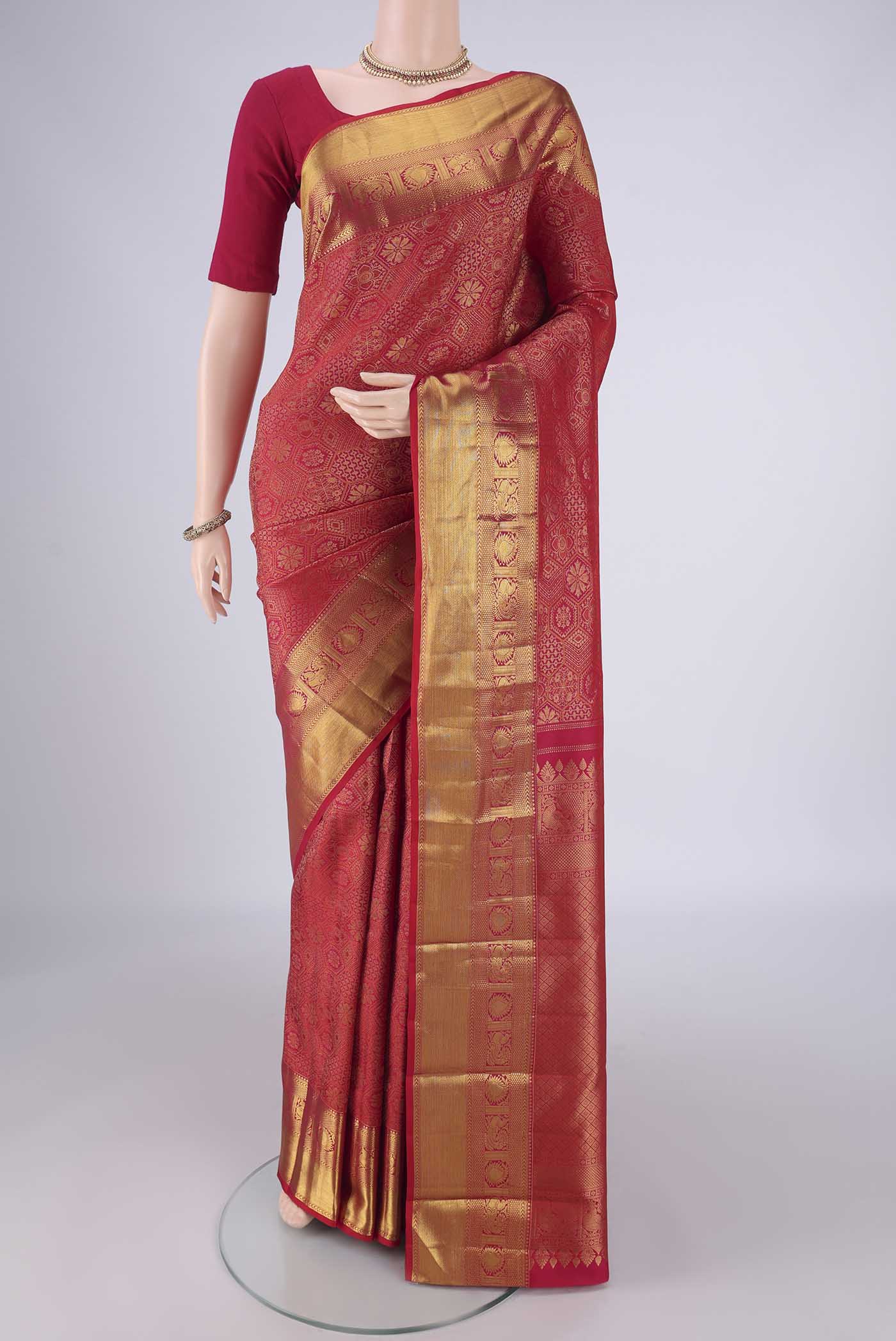 Dark Pink Kanchipuram Silk Saree with Zari Brocade on the body and Zari Border.  displayed on a mannequin
