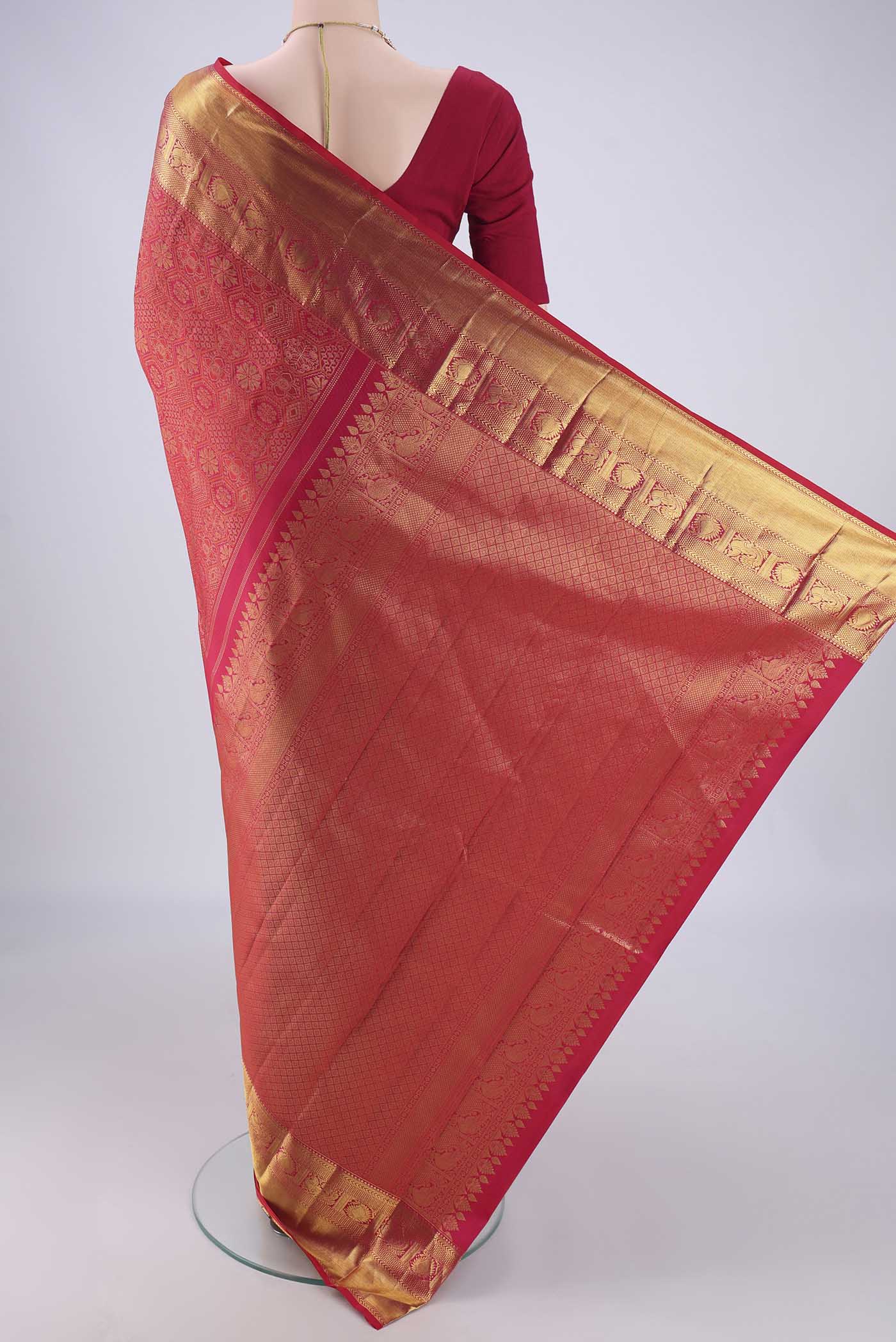 Flat view of Dark Pink Kanchipuram Silk Saree with Zari Brocade on the body and Zari Border. 