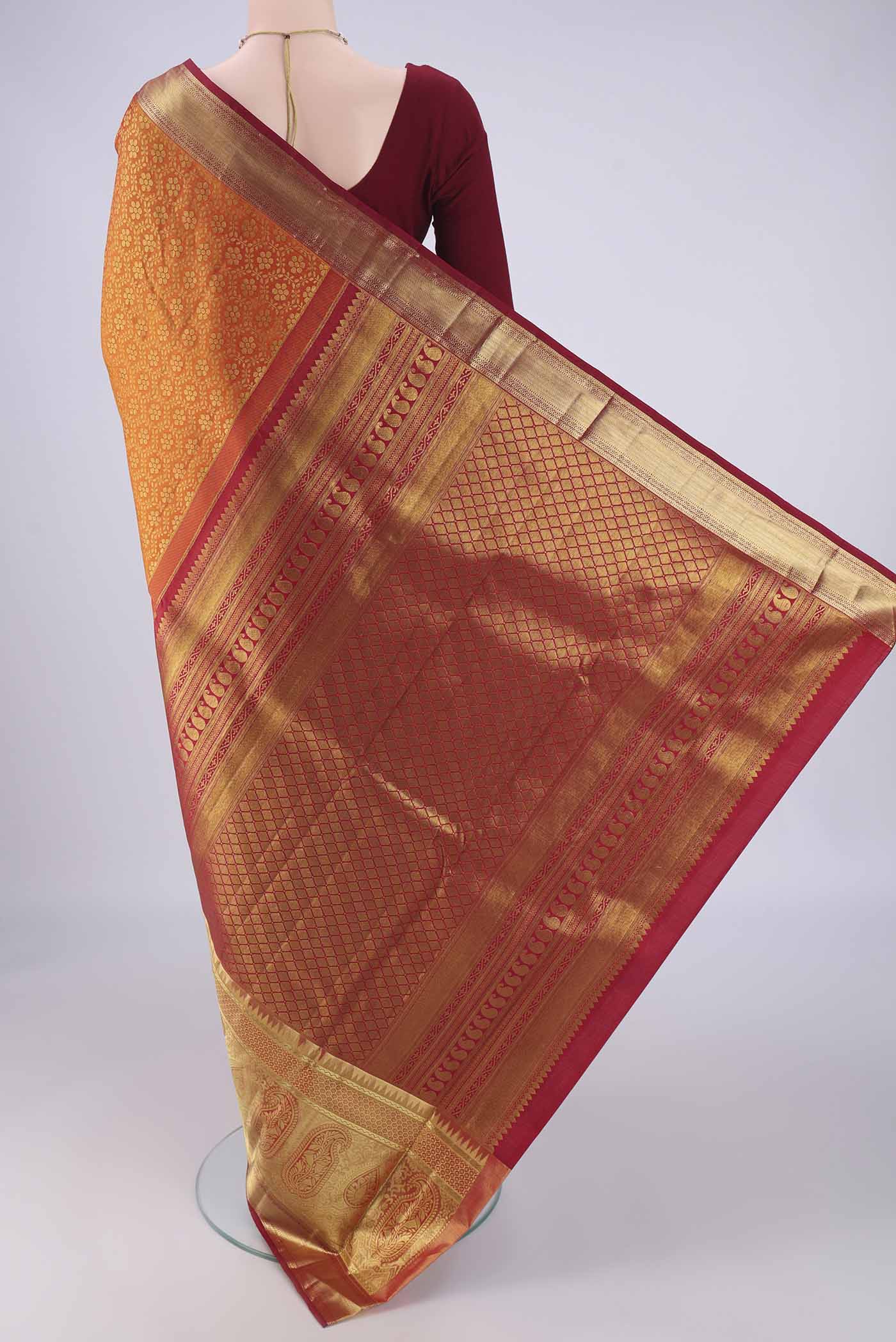 Flat view of Brick Orange Kanjivaram Silk Saree with Zari Brocade on the body and Zari Border. 