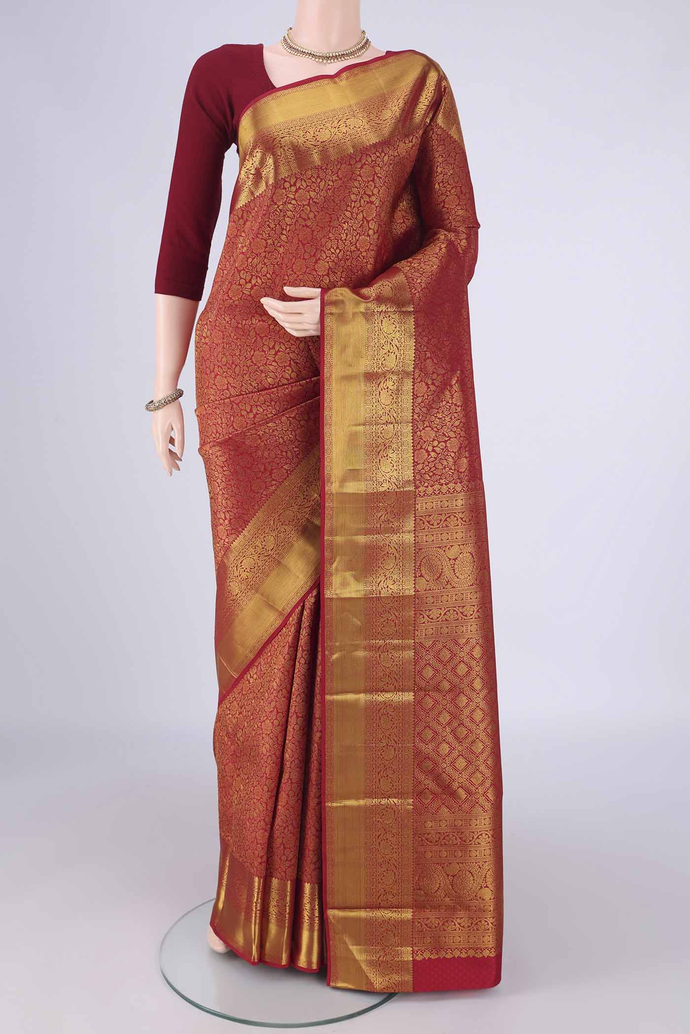 Red Kanjivaram Silk Saree with Zari Brocade on the body and Zari Border.  displayed on a mannequin
