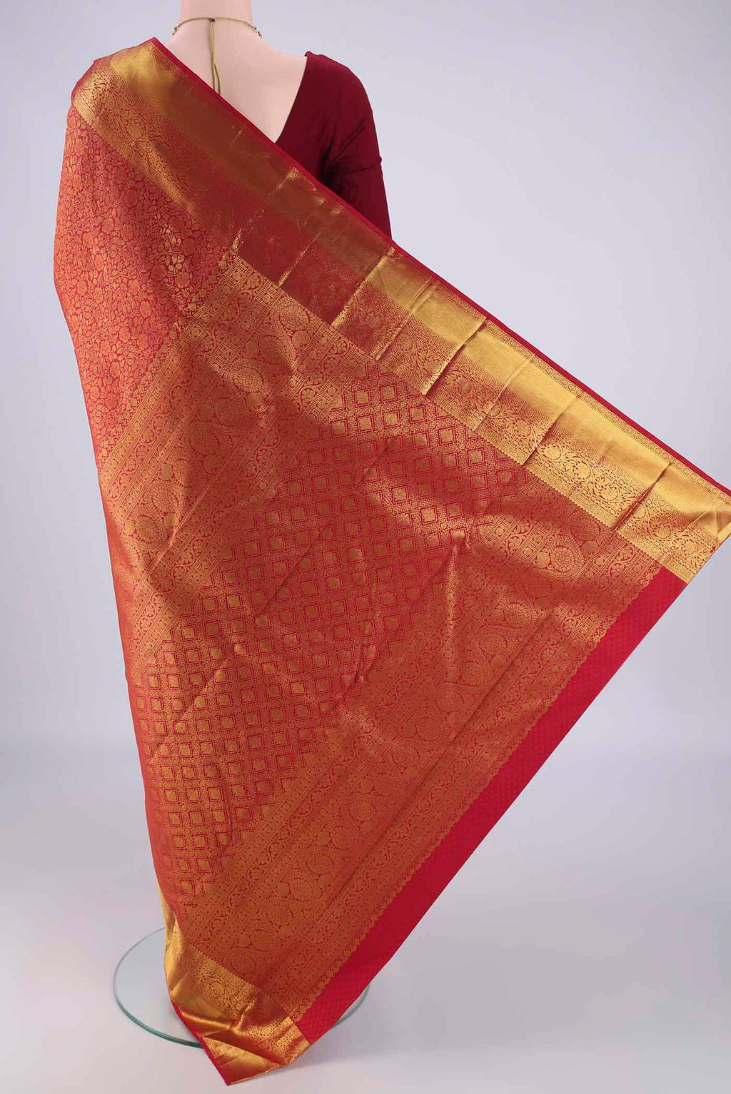 Flat view of Red Kanjivaram Silk Saree with Zari Brocade on the body and Zari Border. 