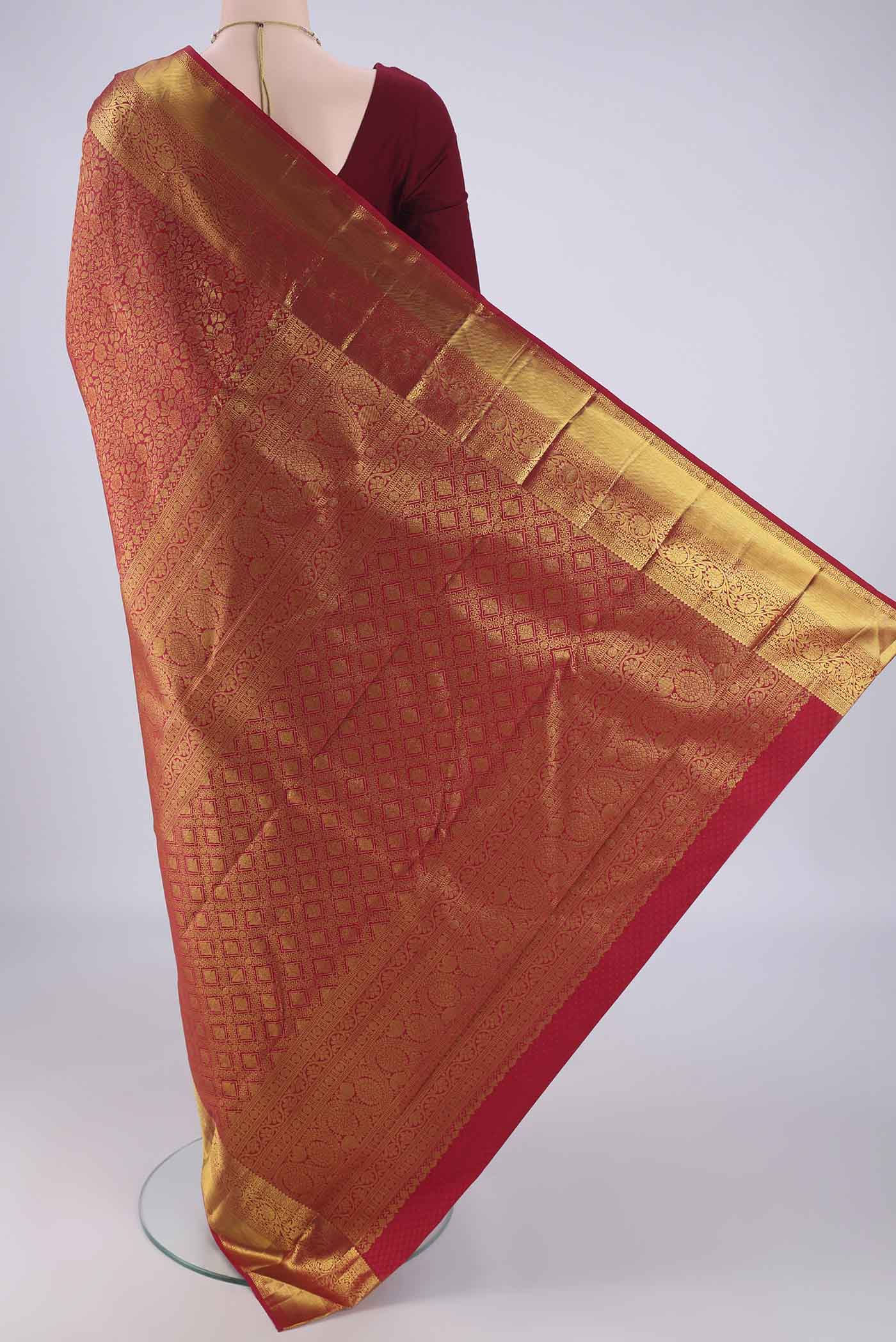 Flat view of Red Kanjivaram Silk Saree with Zari Brocade on the body and Zari Border. 