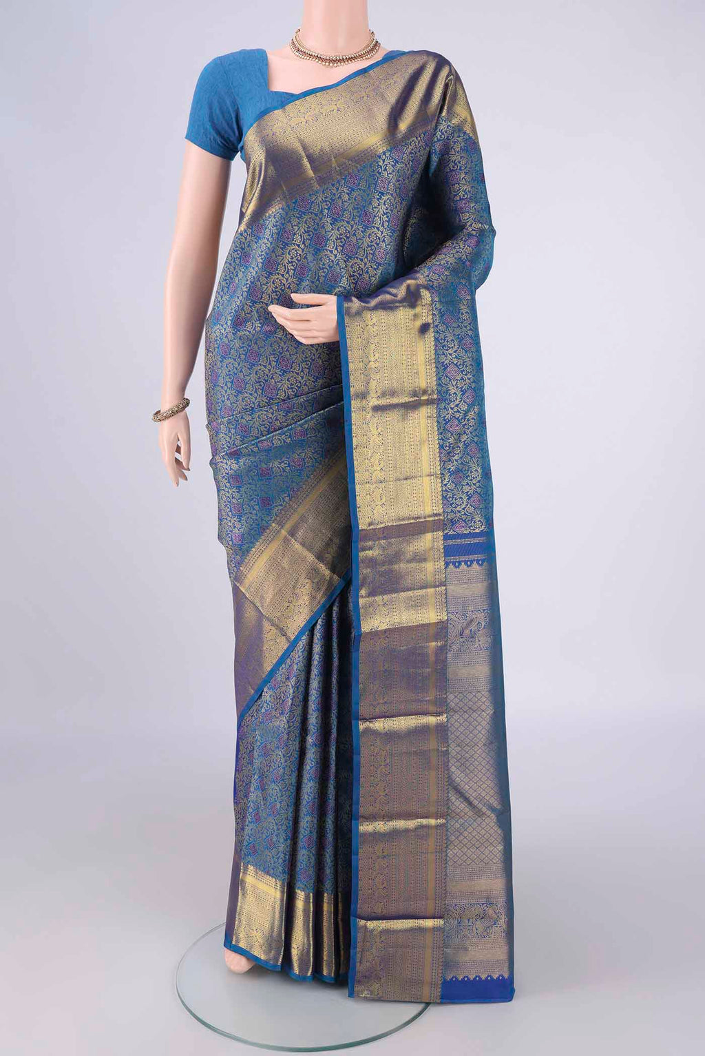 Blue Kanjivaram Silk Saree with Zari Brocade on the body and Zari Border.  displayed on a mannequin