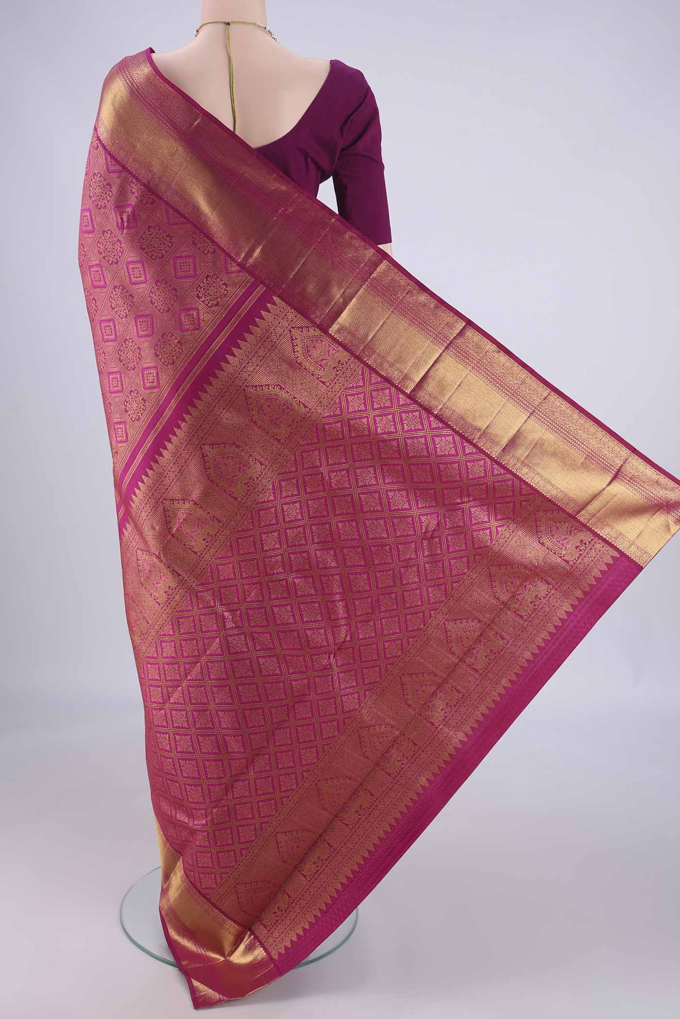 Flat view of Magenta Kanjivaram Silk Saree with Zari Brocade on the body and Zari Border. 